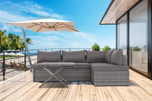 Gray wicker sectional outdoor sofa with dark gray cushions and a folding coffee table