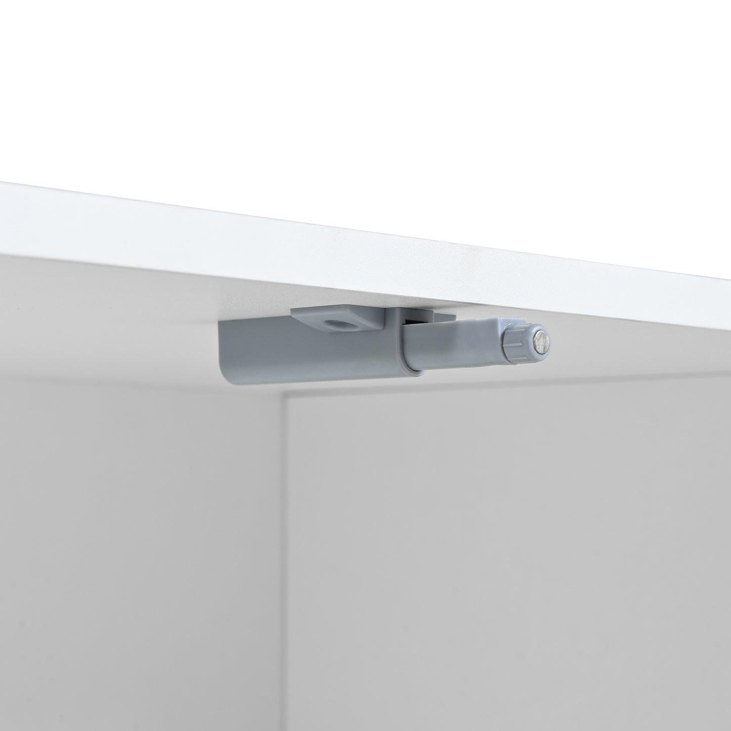 Grey plastic pushtoopen cabinet door latch installed under a white shelf