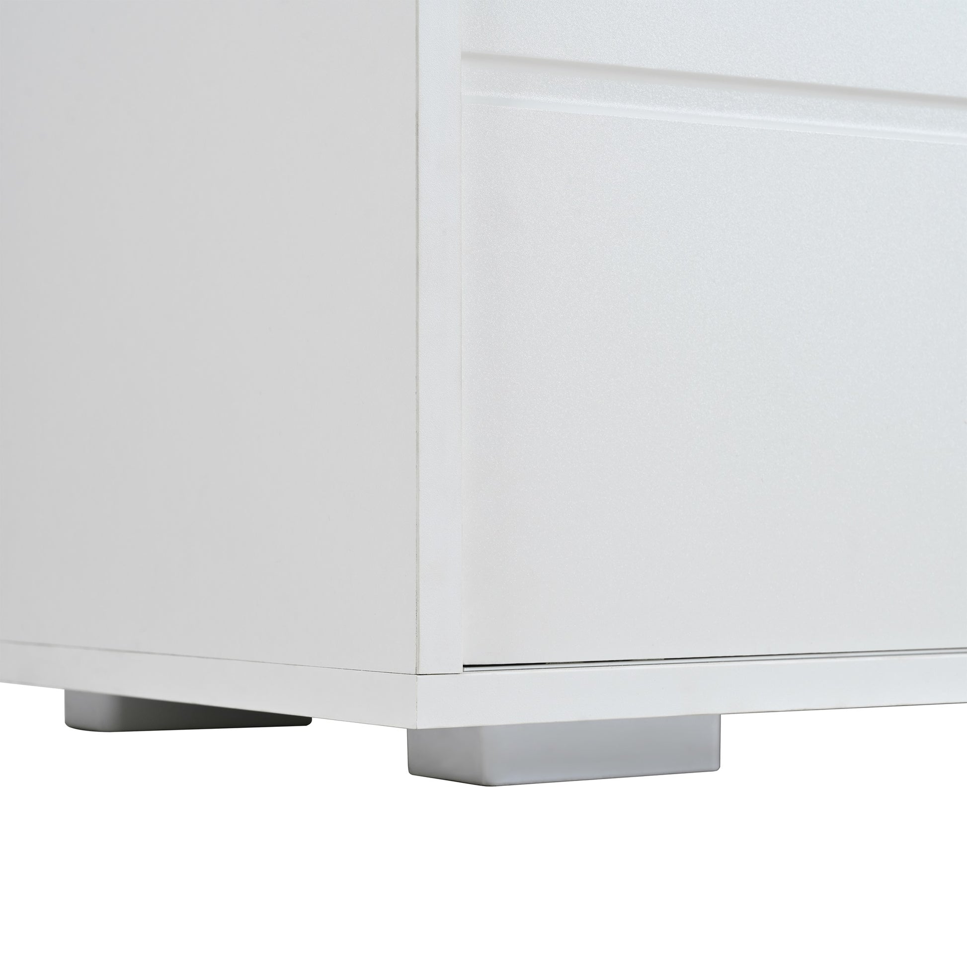 White minimalist dresser drawer detail with sleek metal feet