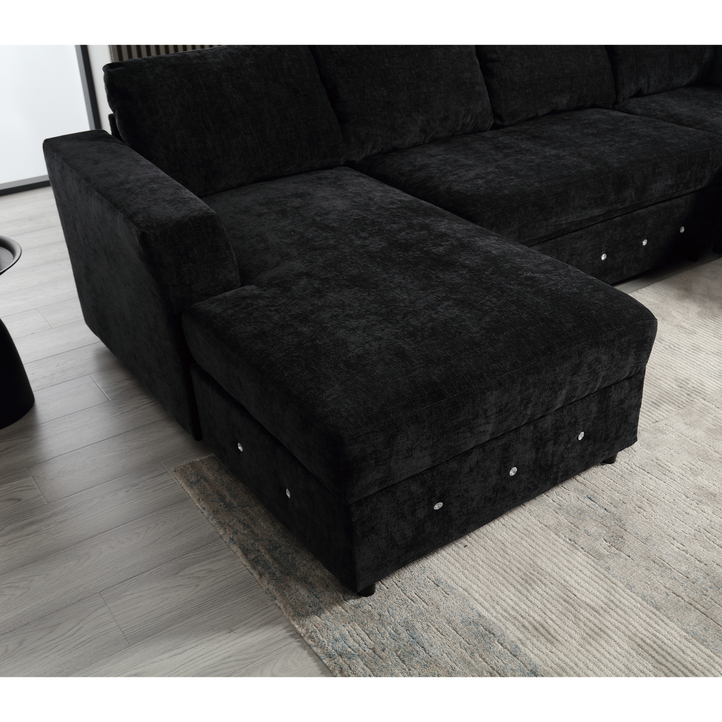 Plush black sectional sofa with storage ottomans and crystal accents