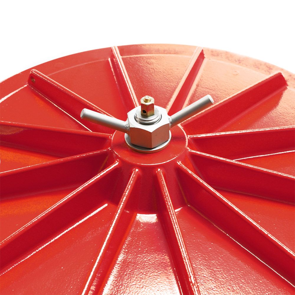 Closeup of a red metal wheel hub with a silver wing nut bolt assembly