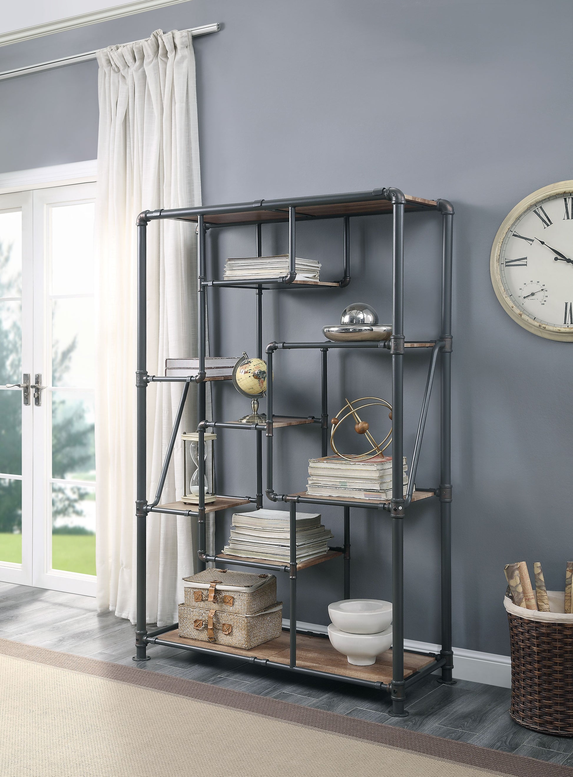 Industrial pipe bookshelf with wood shelves displaying decor