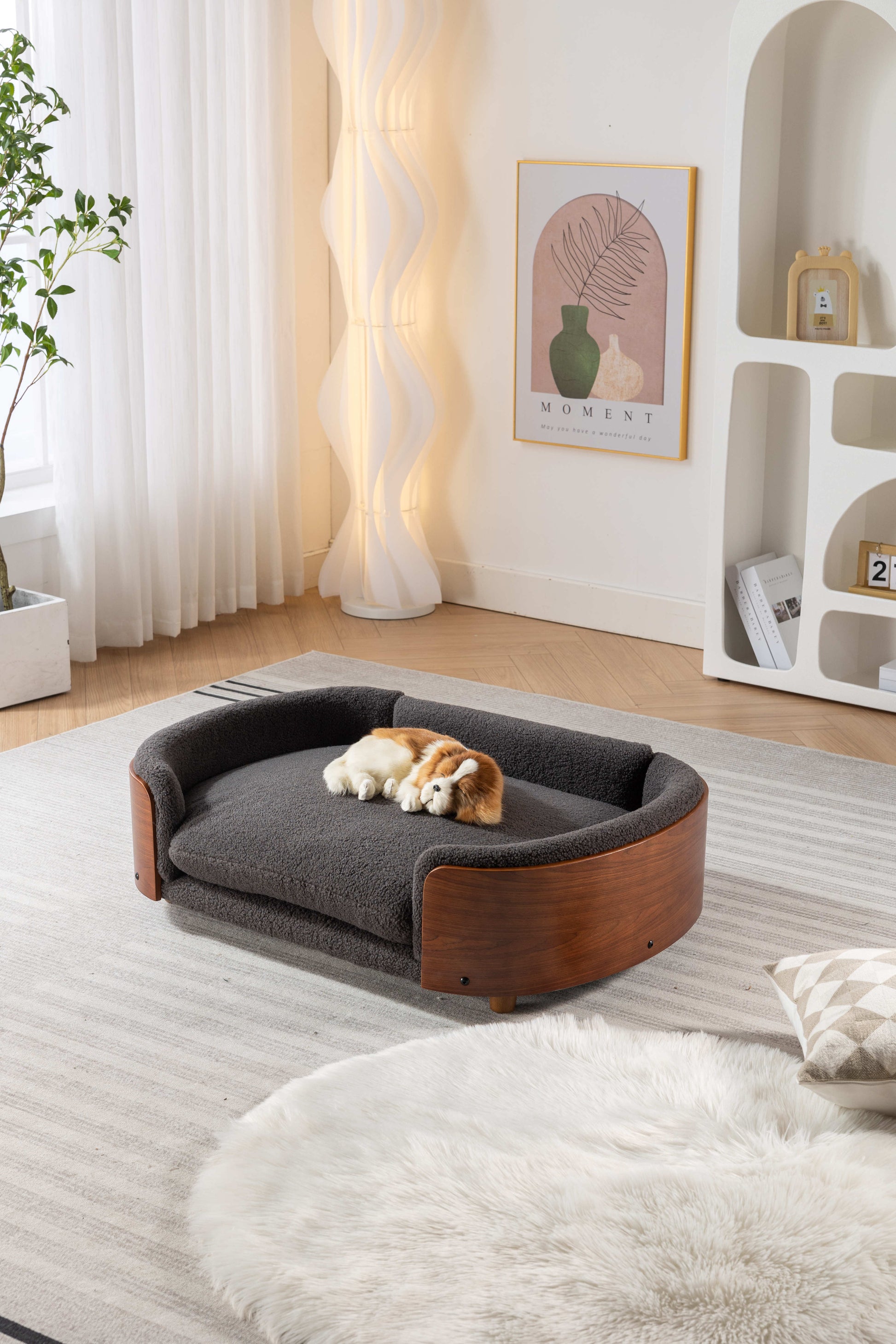 Dark grey boucle pet bed with curved wooden frame and plush cushion for ultimate dog comfort