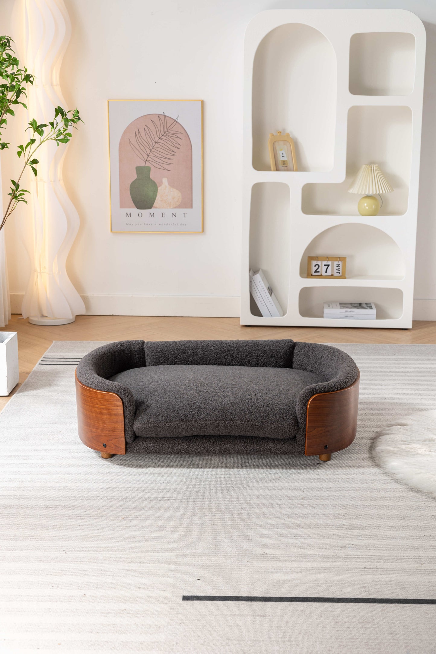Plush grey pet bed with curved wood accents and comfortable bolsters