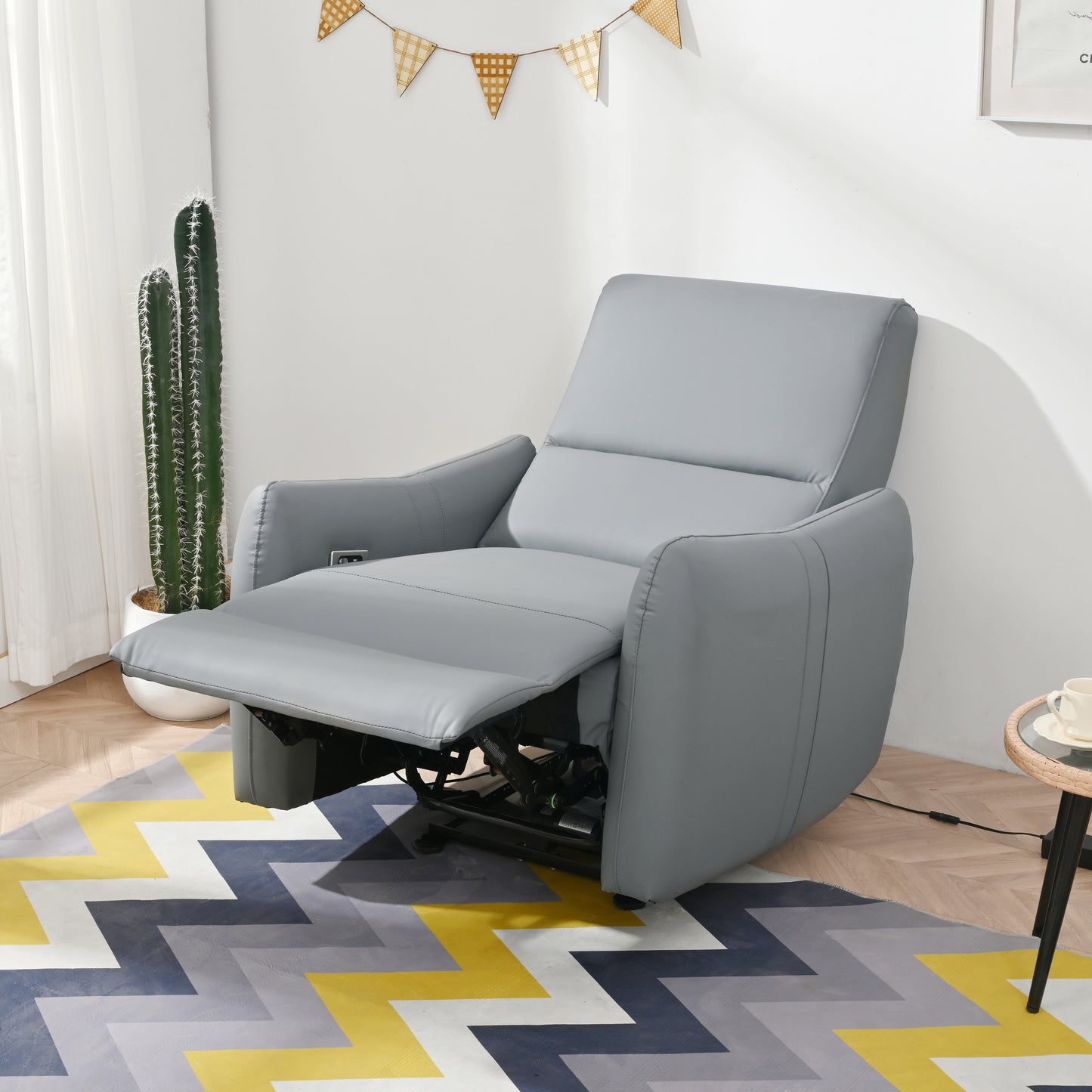 Gray leather power recliner chair with extended footrest and adjustable back for ultimate comfort
