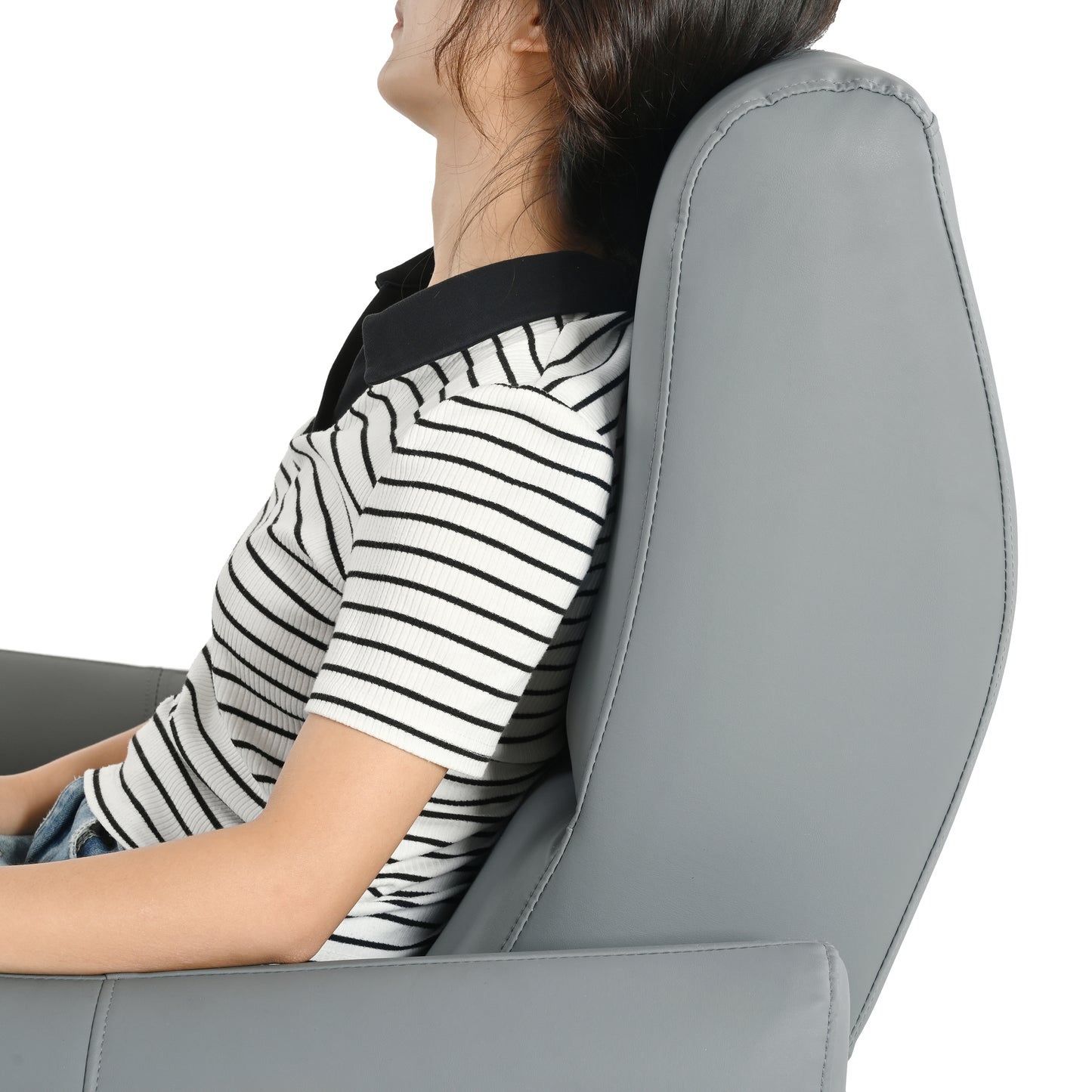 Gray faux leather recliner chair with a woman relaxing against its padded headrest