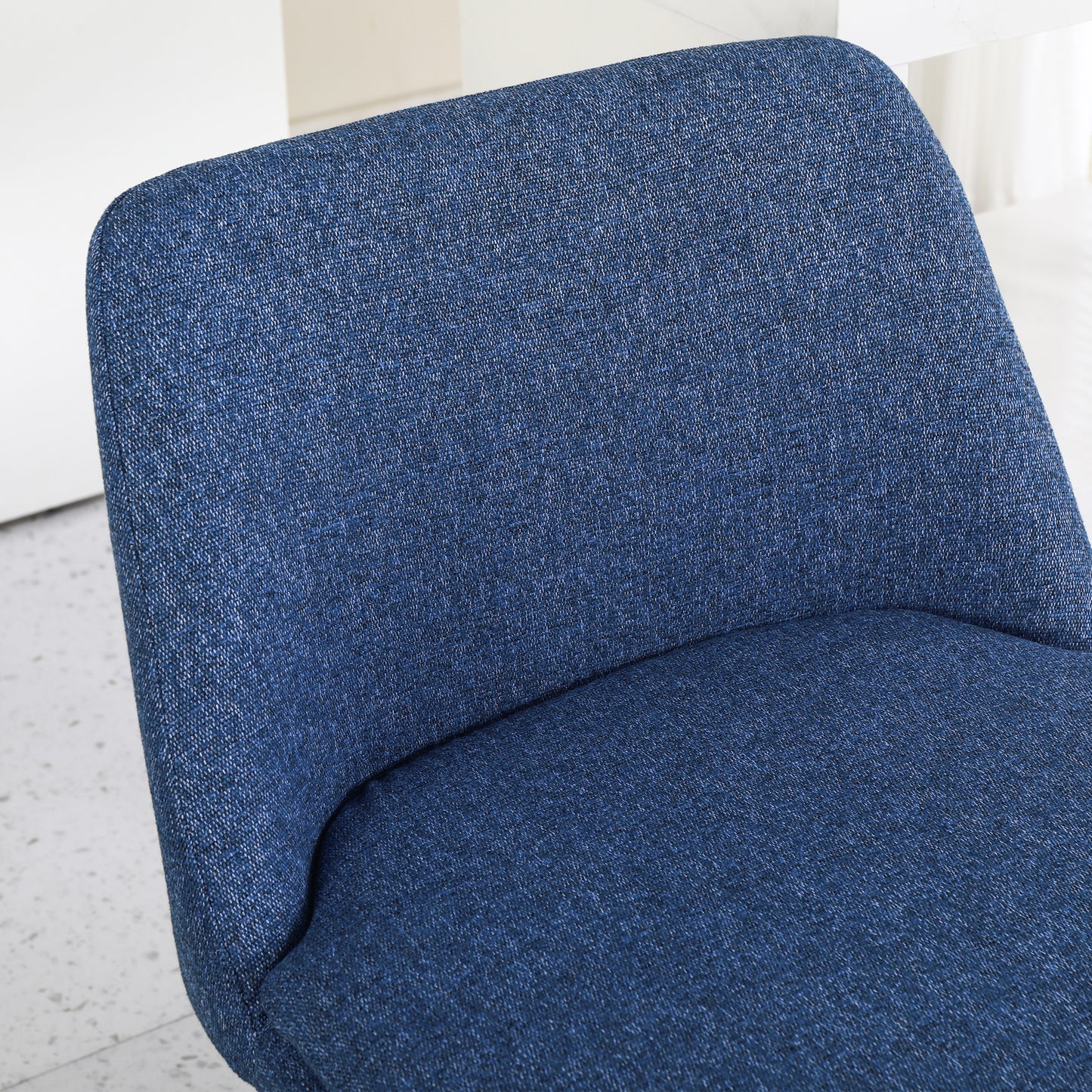Textured navy blue upholstered dining chair back and seat detail