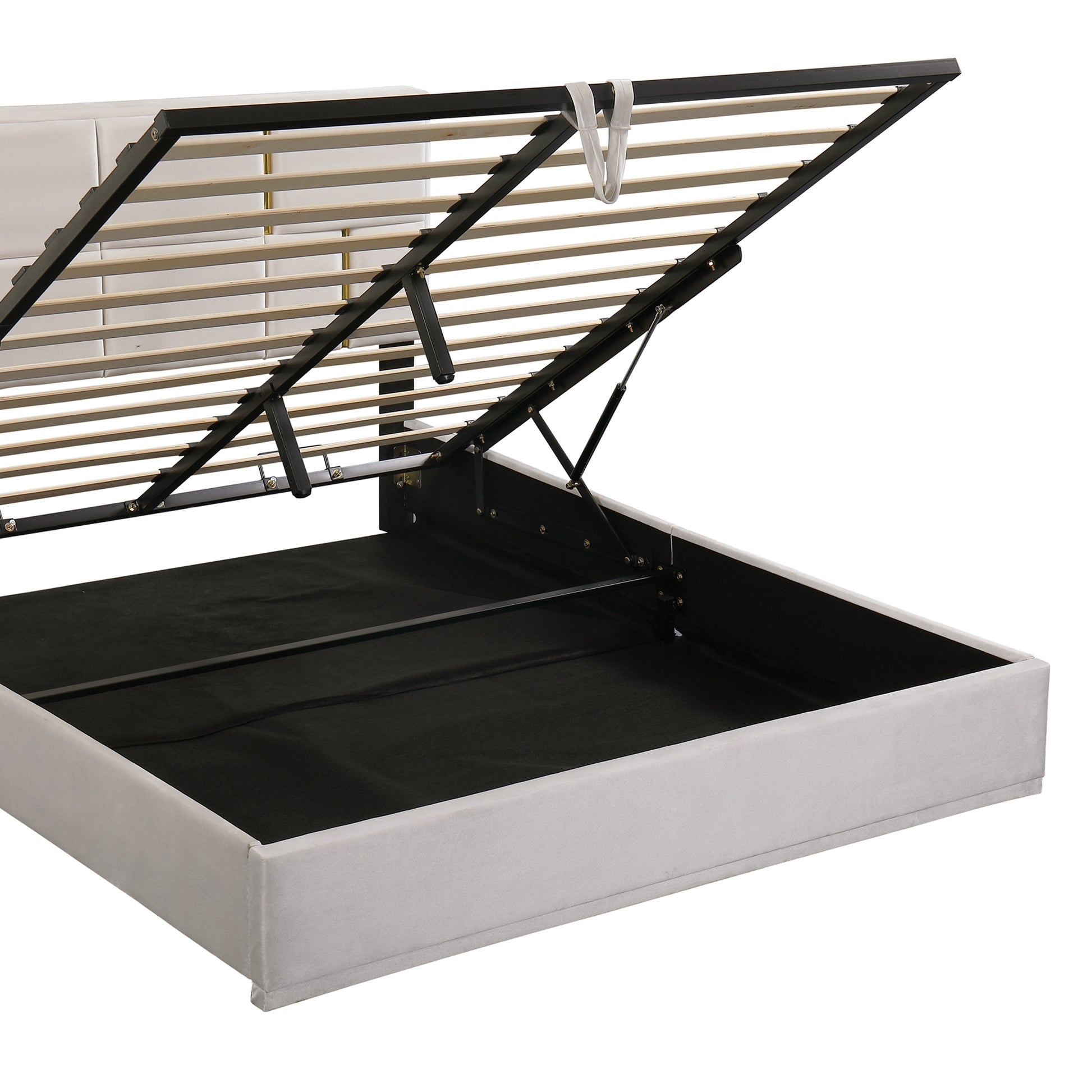 Grey upholstered bed frame with hydraulic lift storage mechanism exposed
