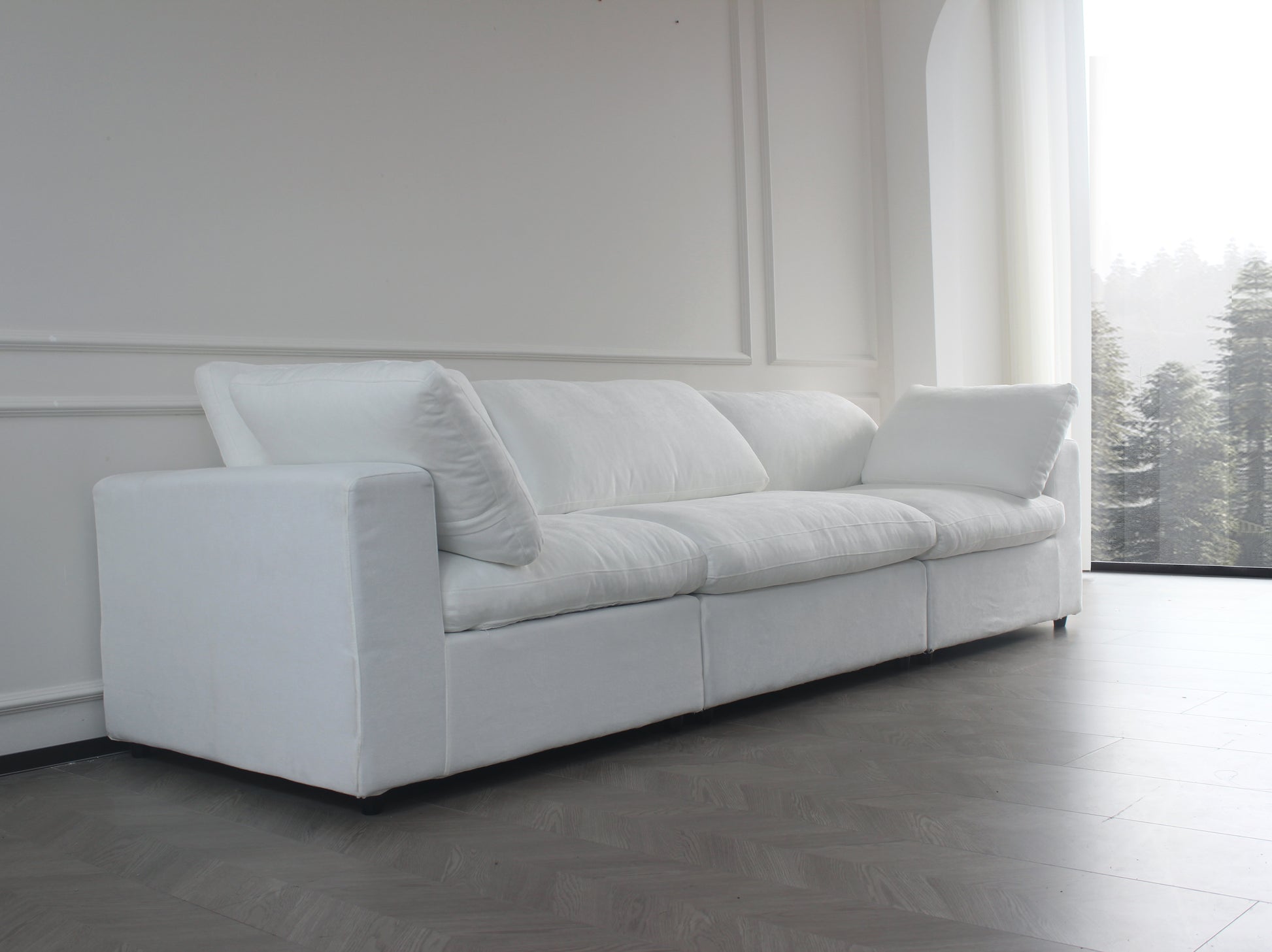 Plush white linen sofa with deep cushions and three seats ideal for a modern living room