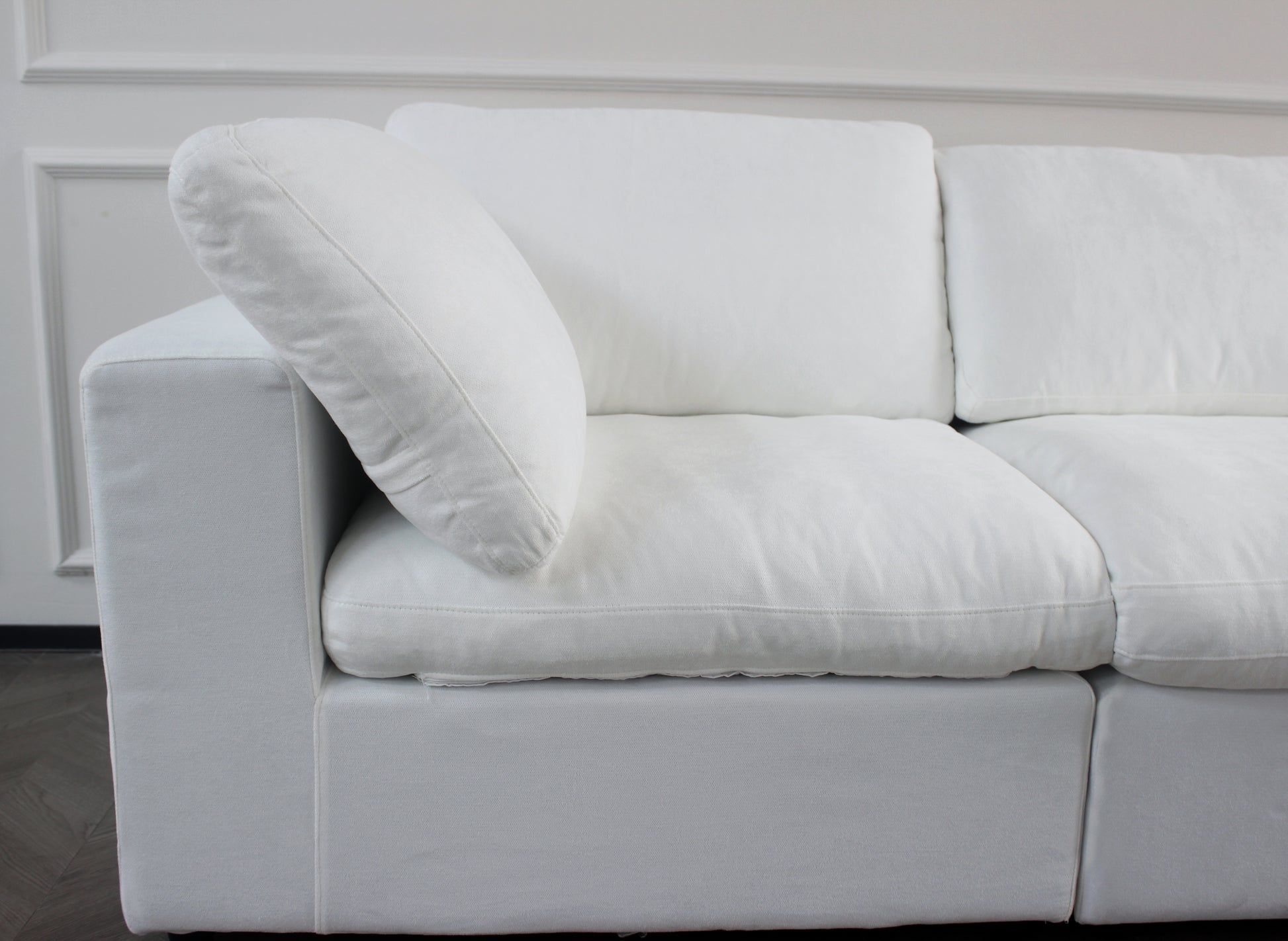 Comfortable white fabric sofa with plush cushions perfect for modern living room decor
