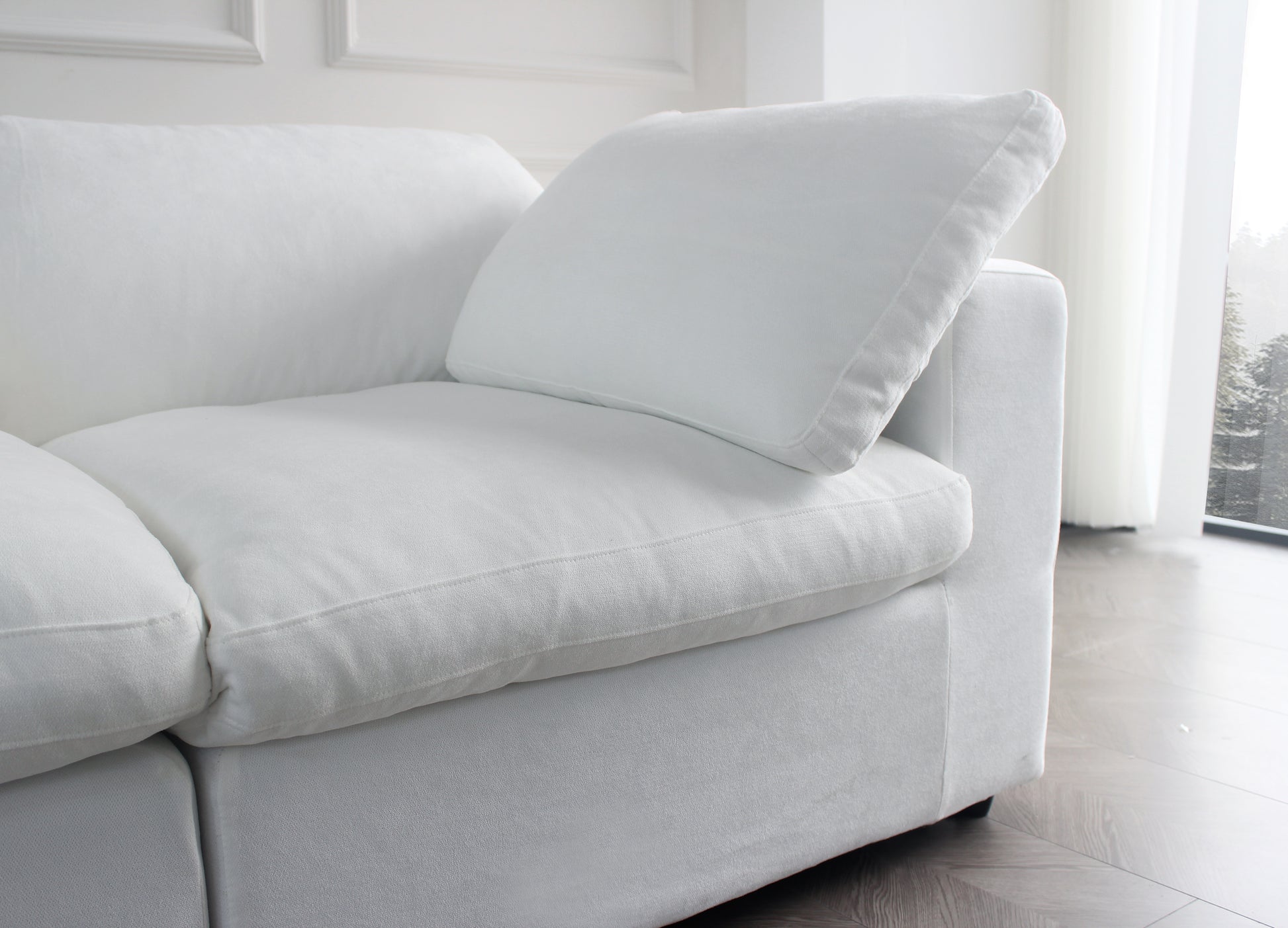 Plush white linen sectional sofa with deep comfortable cushions and accent pillows