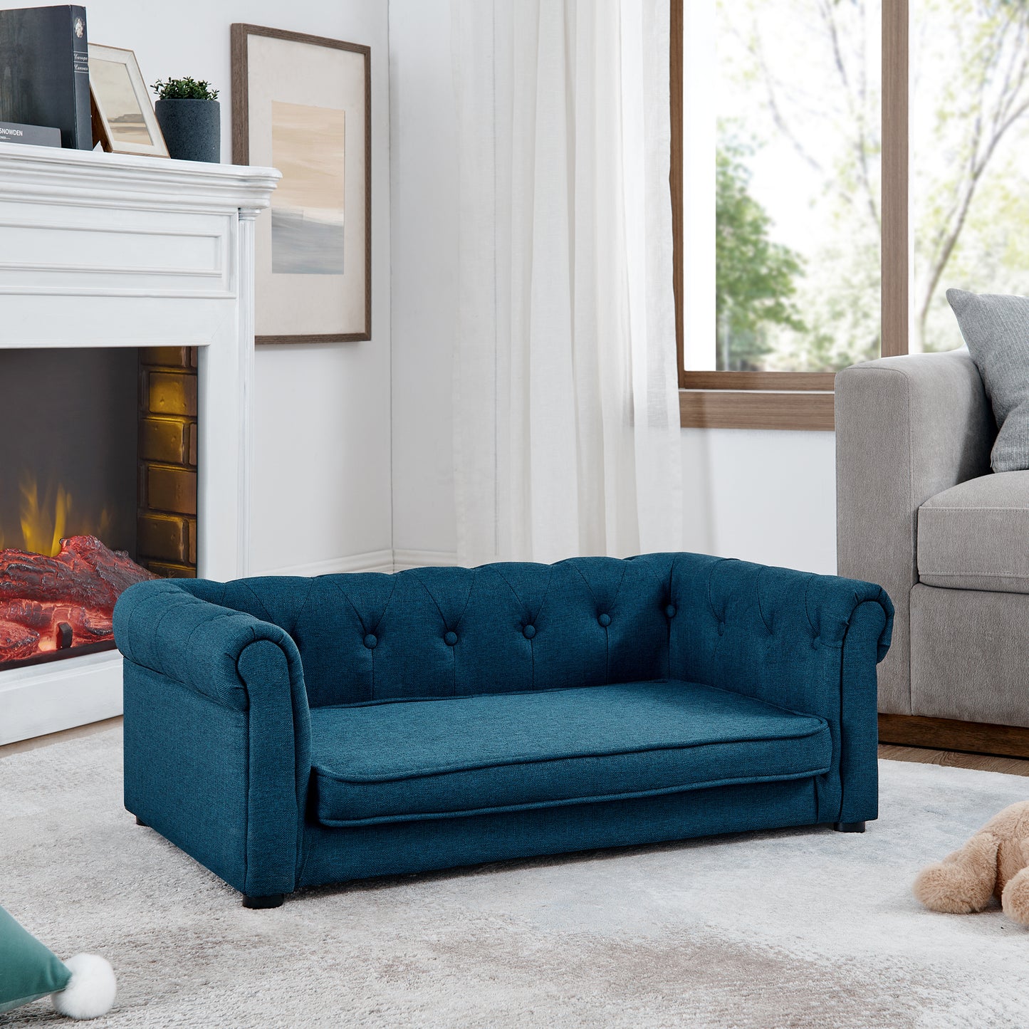 Tufted teal blue fabric pet sofa with rolled arms and plush cushion