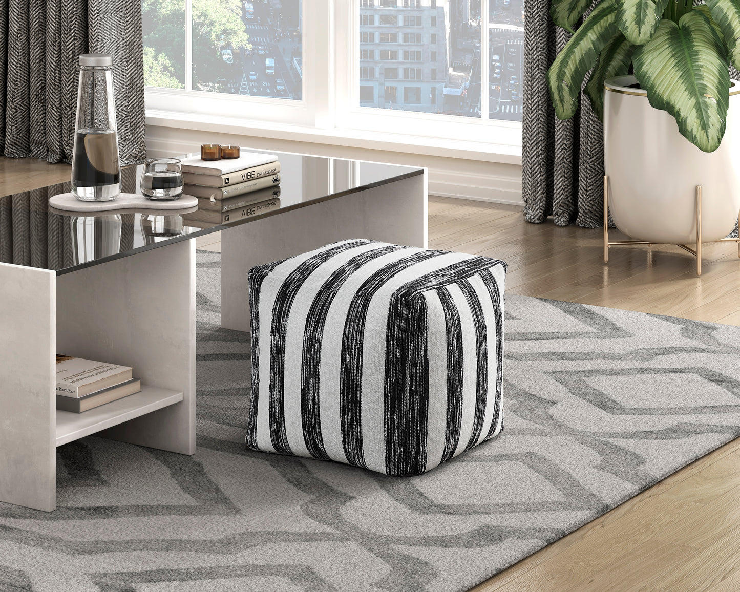 Black and white striped upholstered ottoman perfect for adding a modern touch to any living room