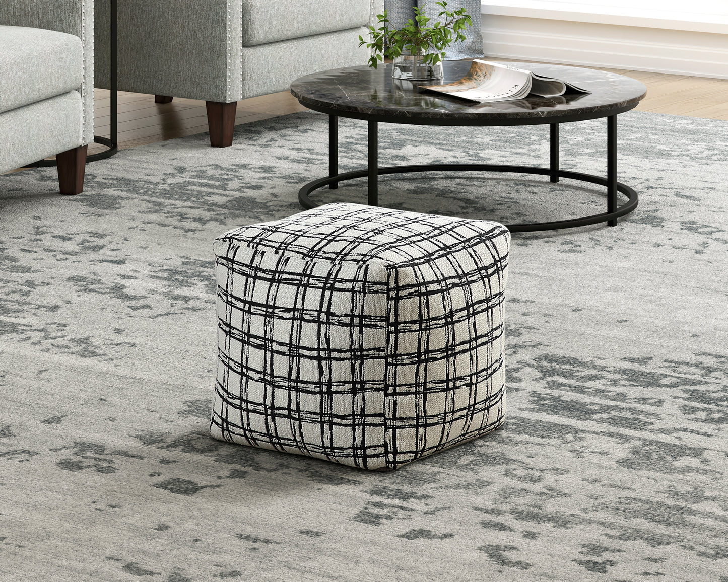 Square ottoman with a textured black and white plaid pattern perfect for modern living rooms