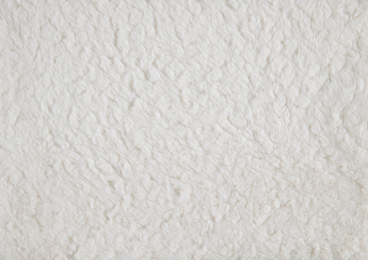 Creamy white faux fur fabric texture perfect for soft textiles