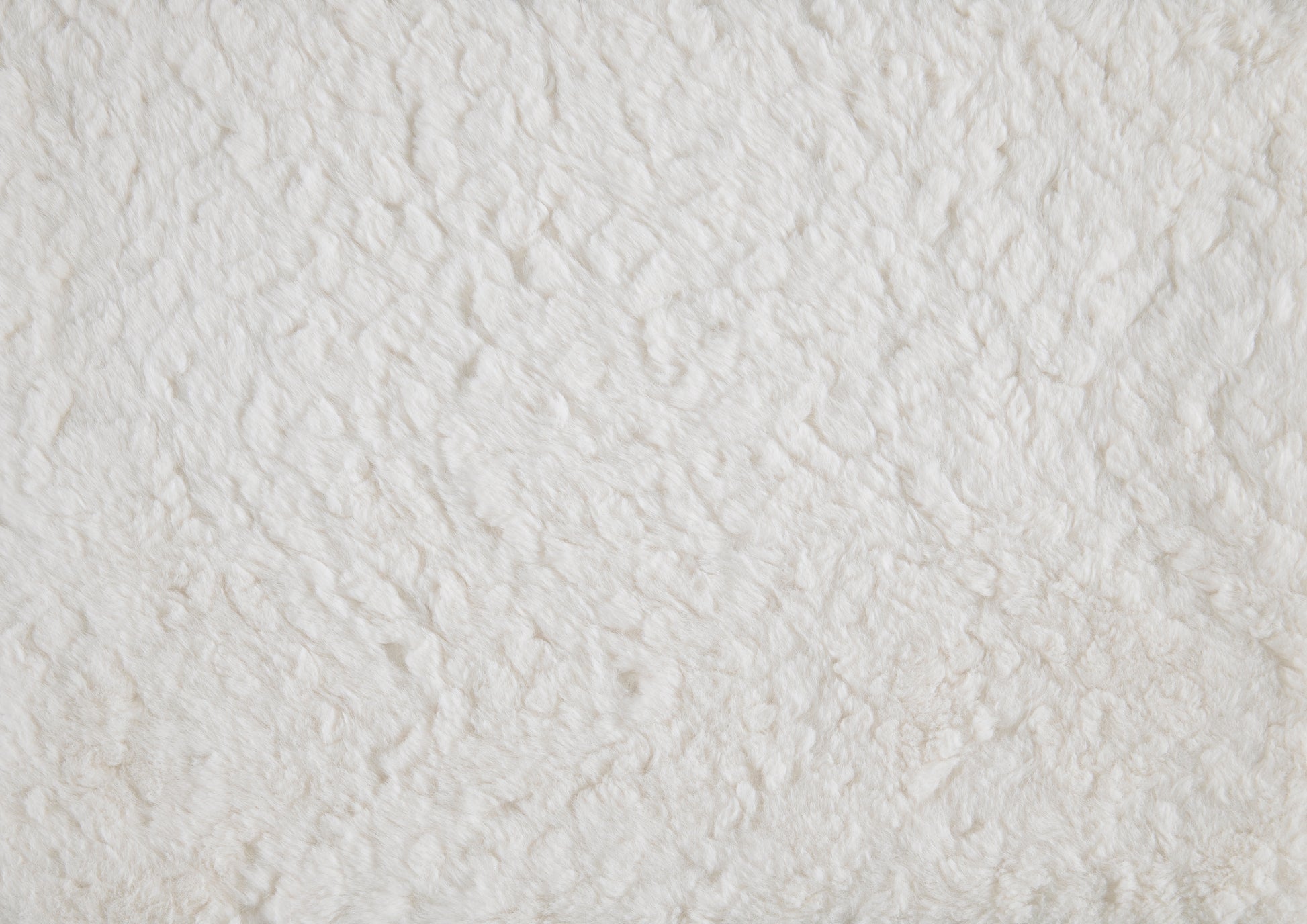 Creamy white faux fur fabric texture perfect for soft textiles