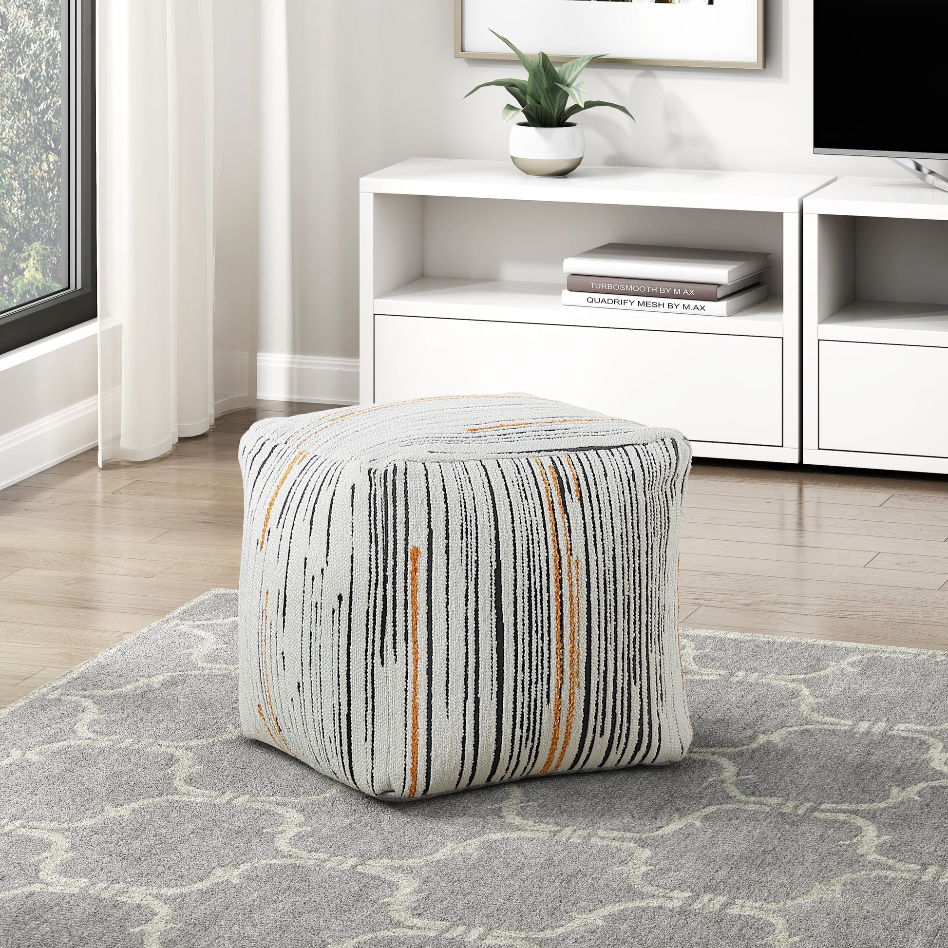 Textured cube ottoman with vertical black and orange stripes on cream background