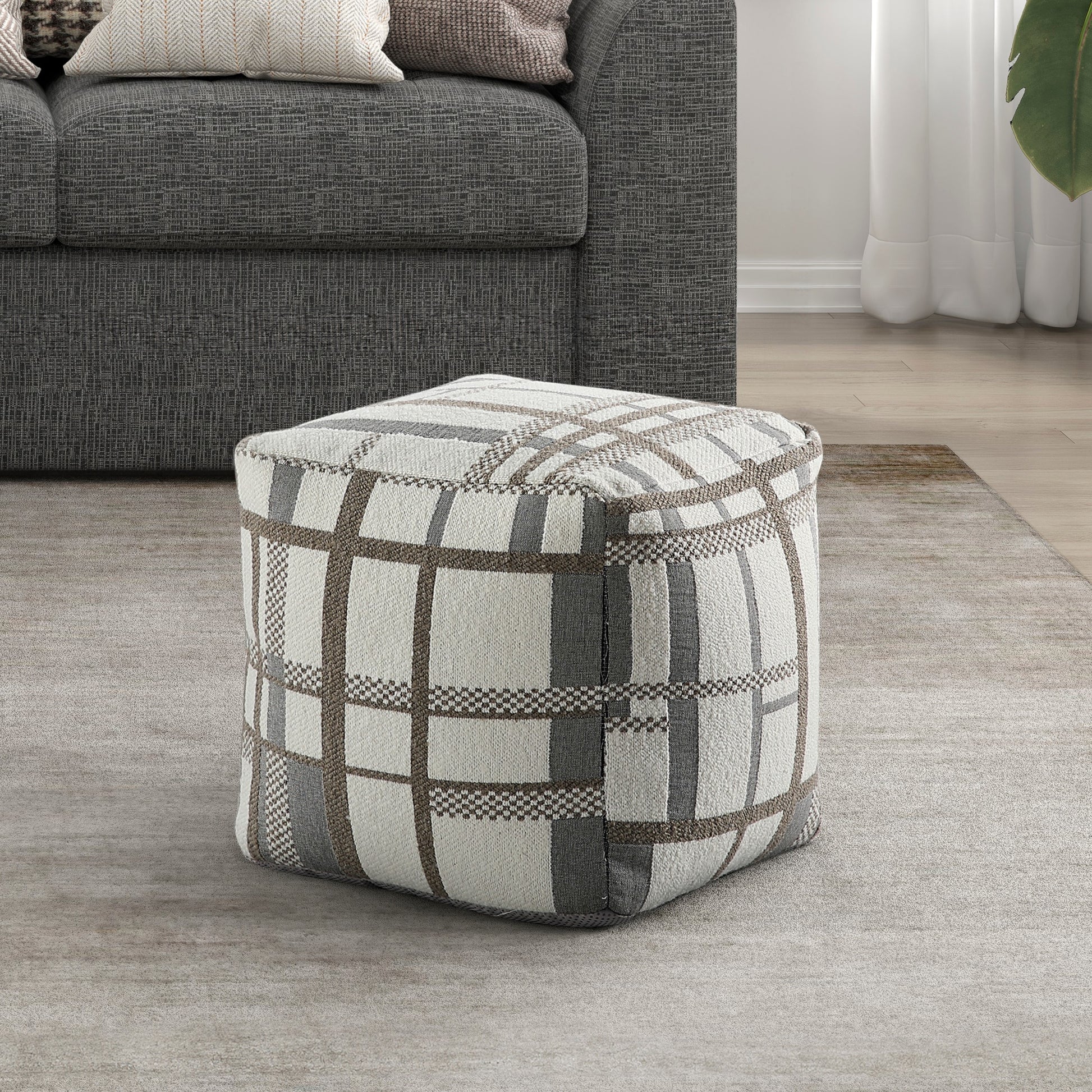 Plush square ottoman with a modern gray and white plaid fabric design perfect for footrest or extra seating
