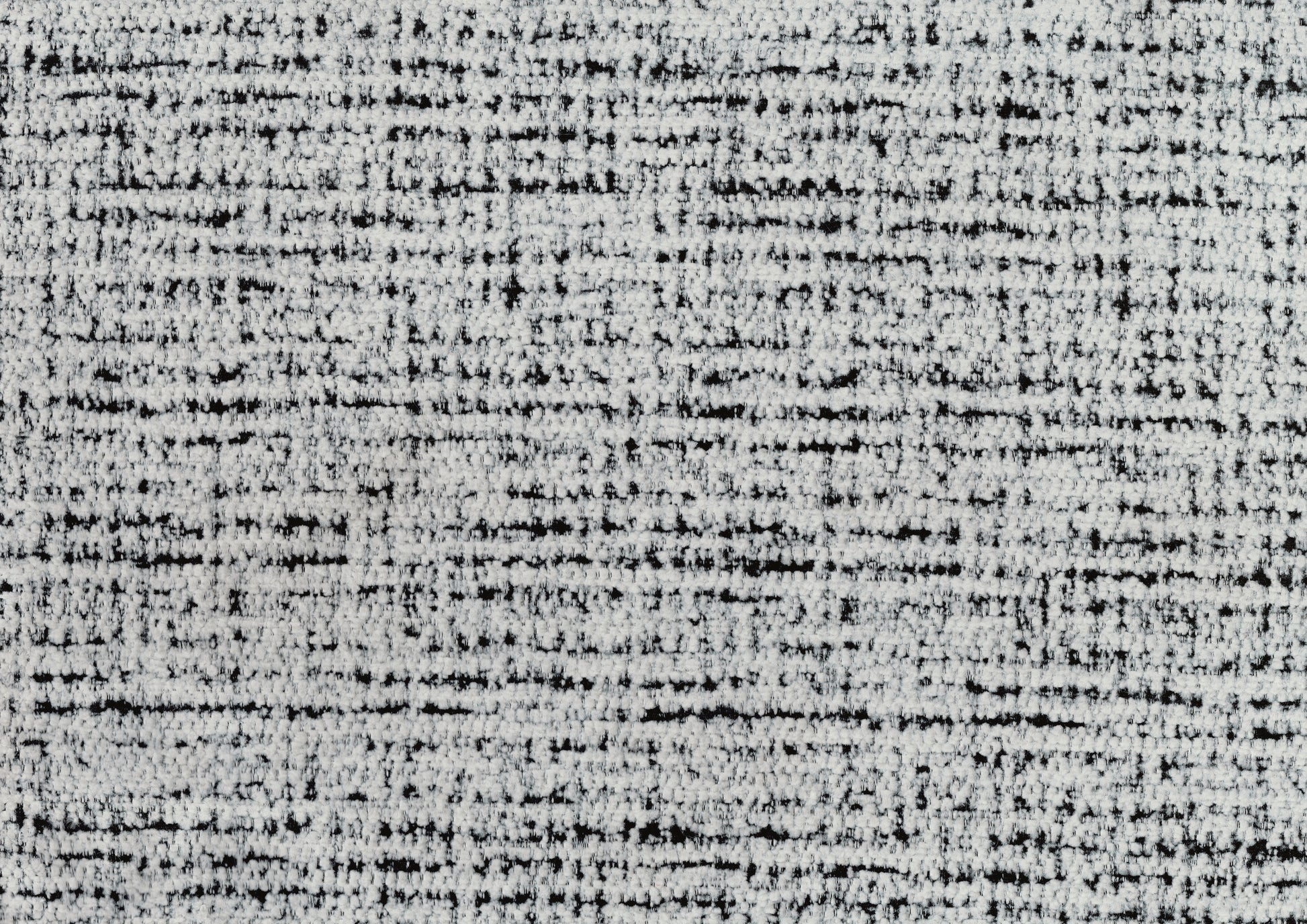 Closeup of textured white and black tweed fabric ideal for upholstery and apparel