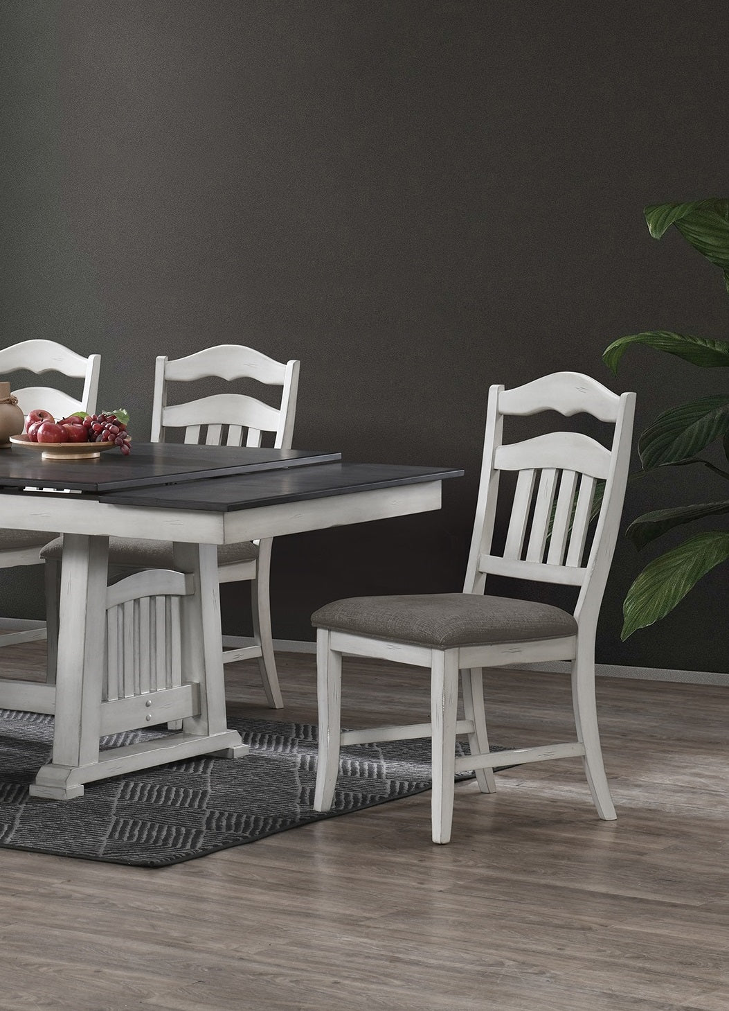 White wooden dining chair with upholstered grey seat perfect for a farmhouse kitchen