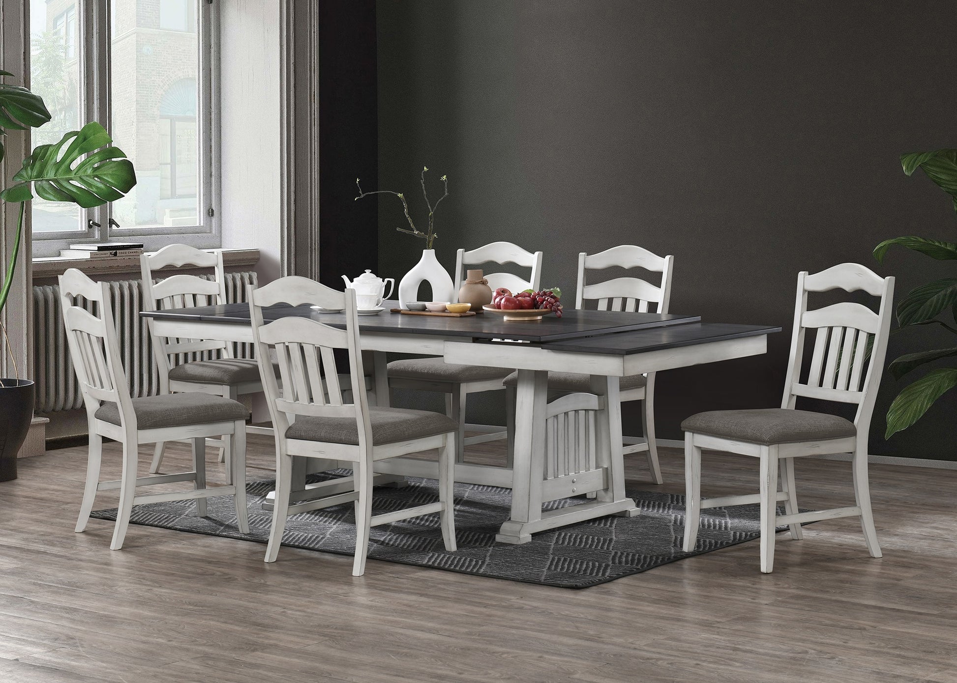 Modern farmhouse dining table with six distressed white chairs seating six