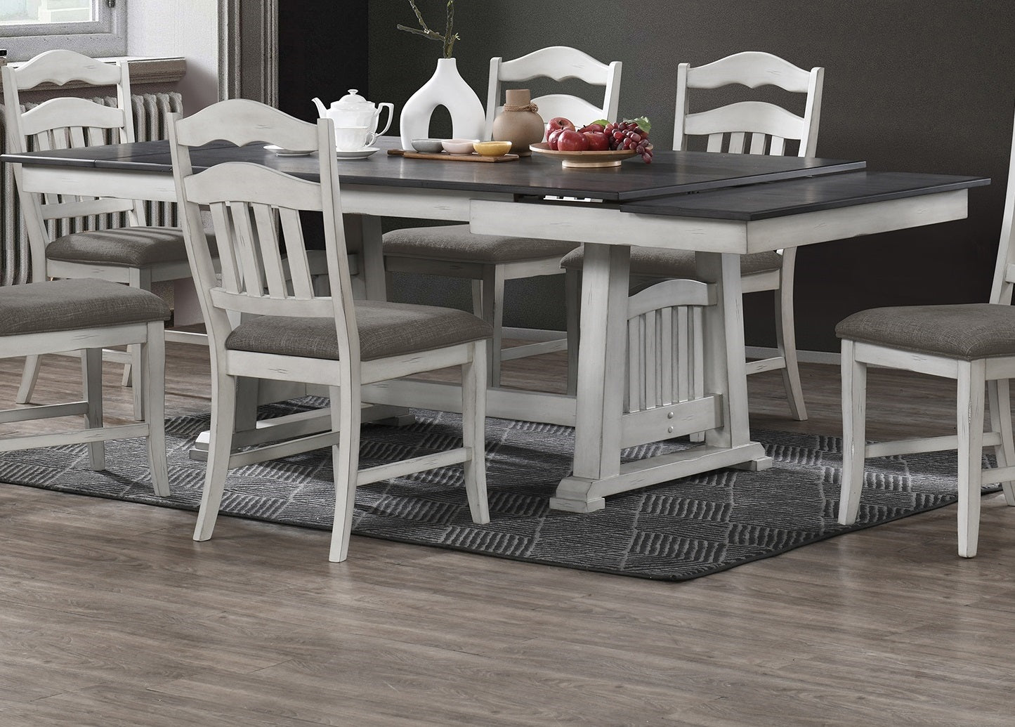 Distressed white wood counter height dining table with dark gray top and upholstered stools