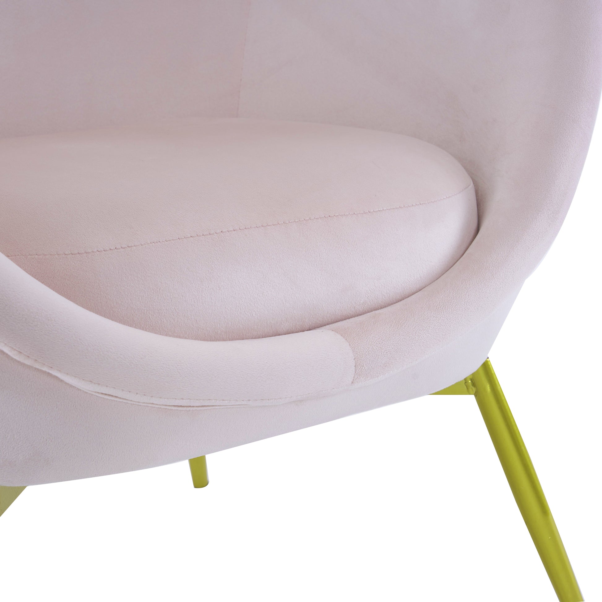 Pale pink velvet armchair with curved back and lime green metal legs