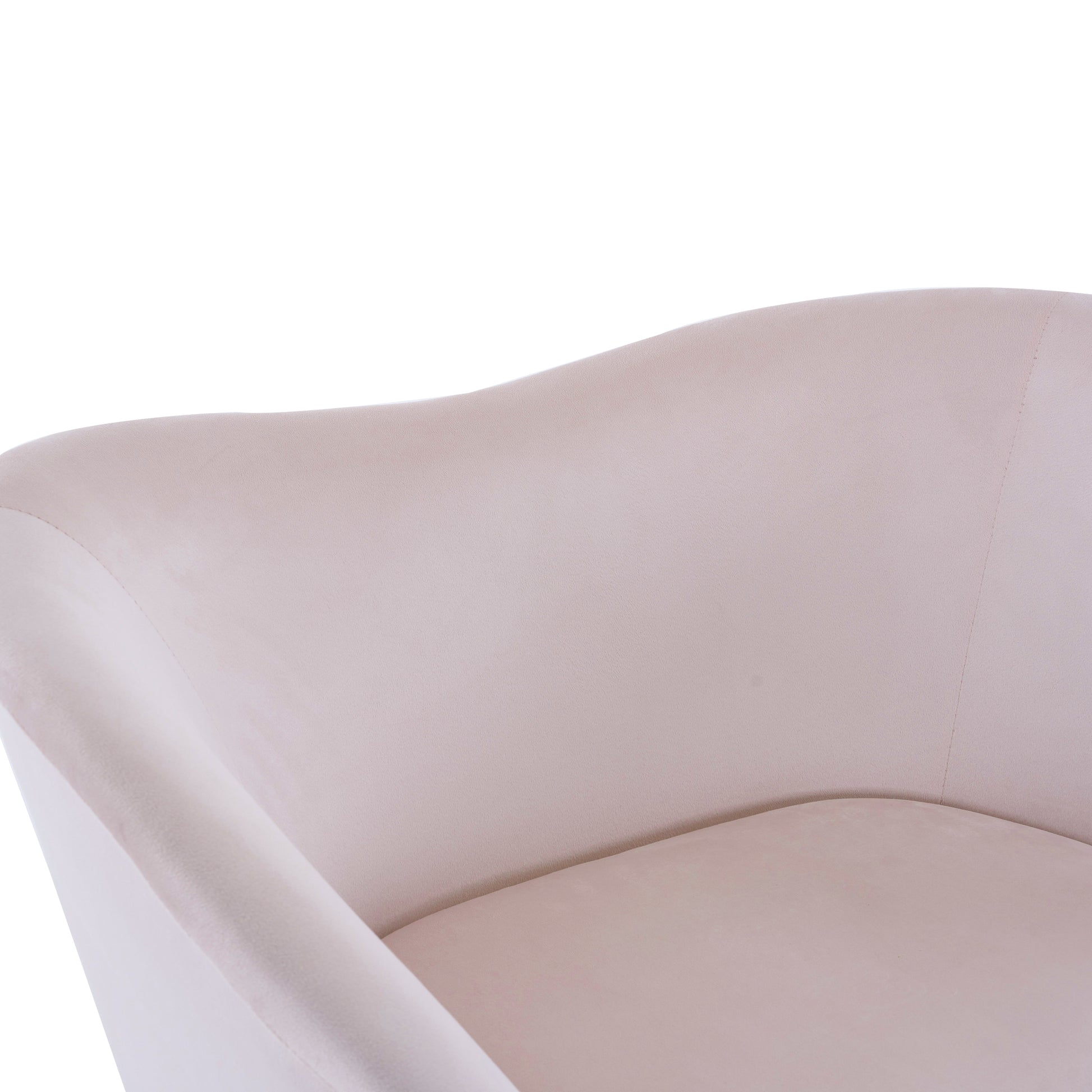 Closeup of a plush velvet accent chair in a soft beige hue