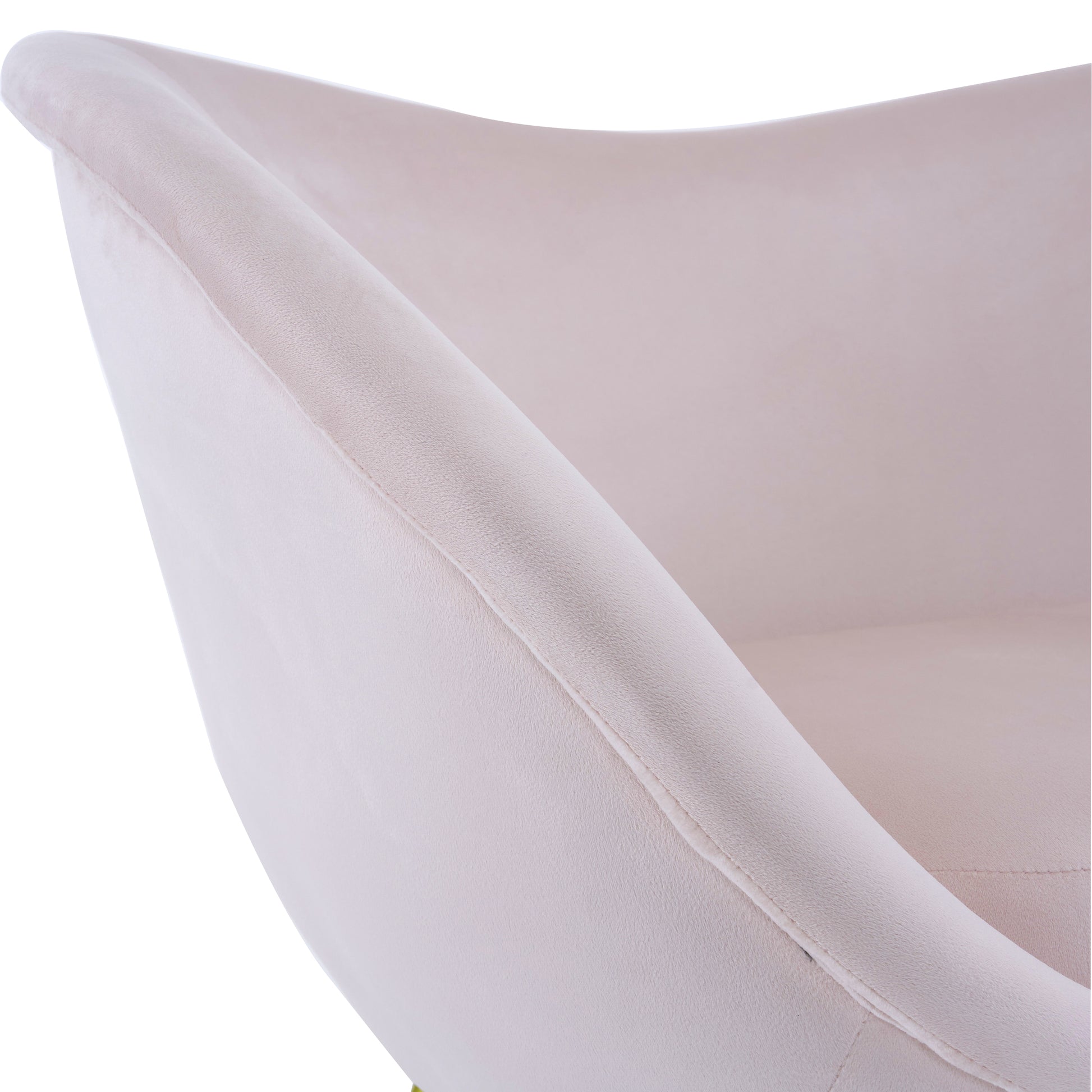 Closeup of a plush blush velvet accent chairs curved armrest