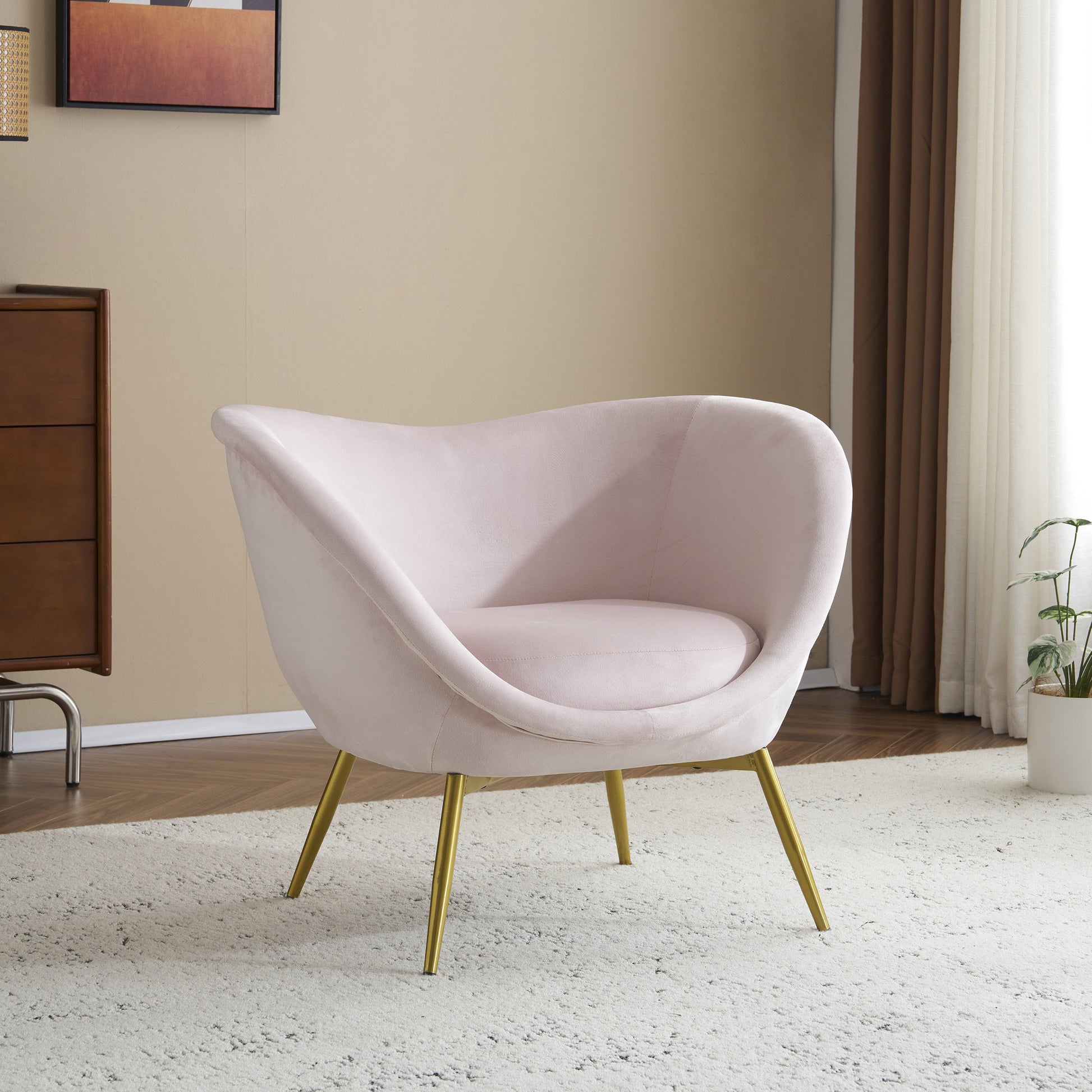 Light pink velvet accent chair with gold tapered legs perfect for modern living rooms