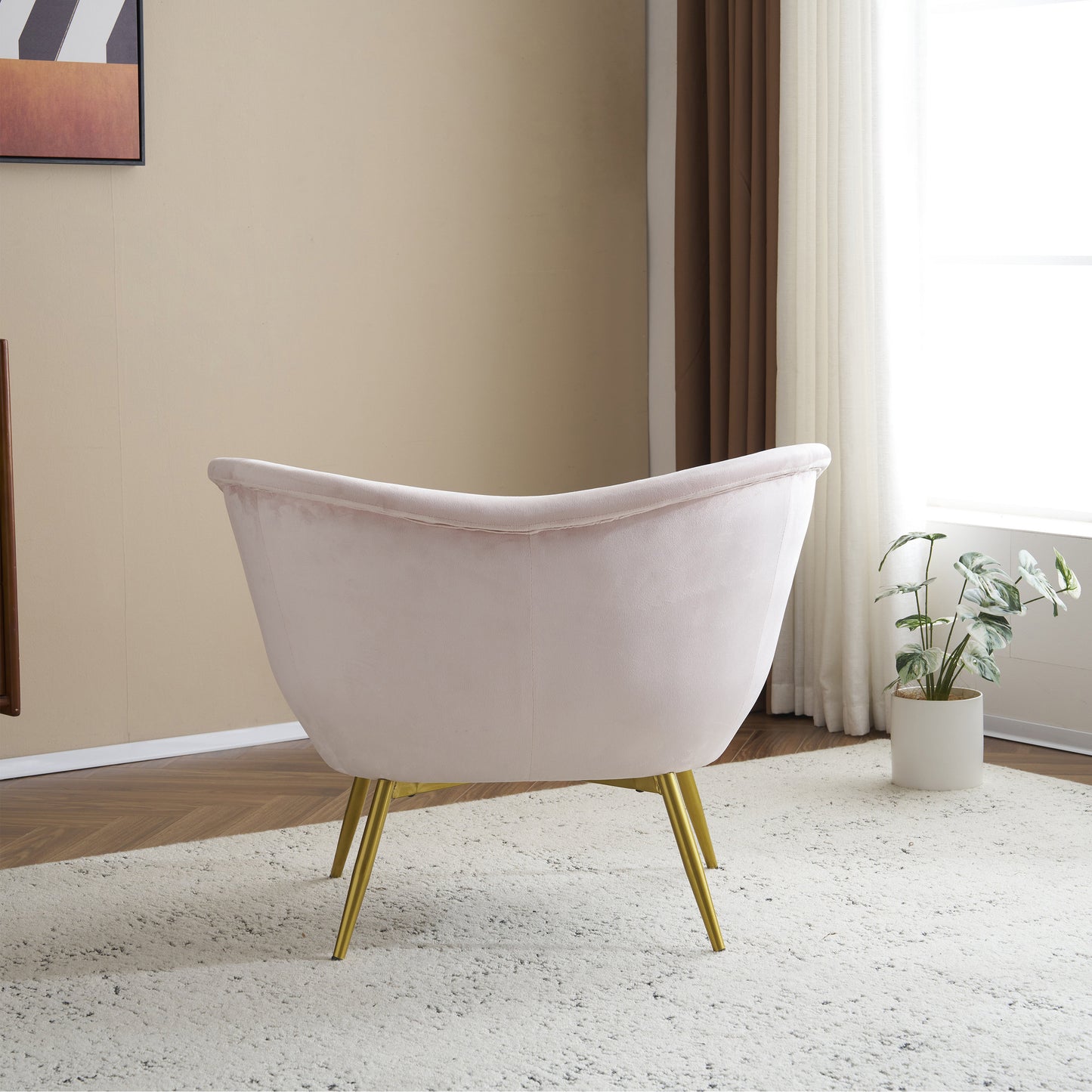 Pale pink velvet accent chair with gold hairpin legs perfect for modern living rooms