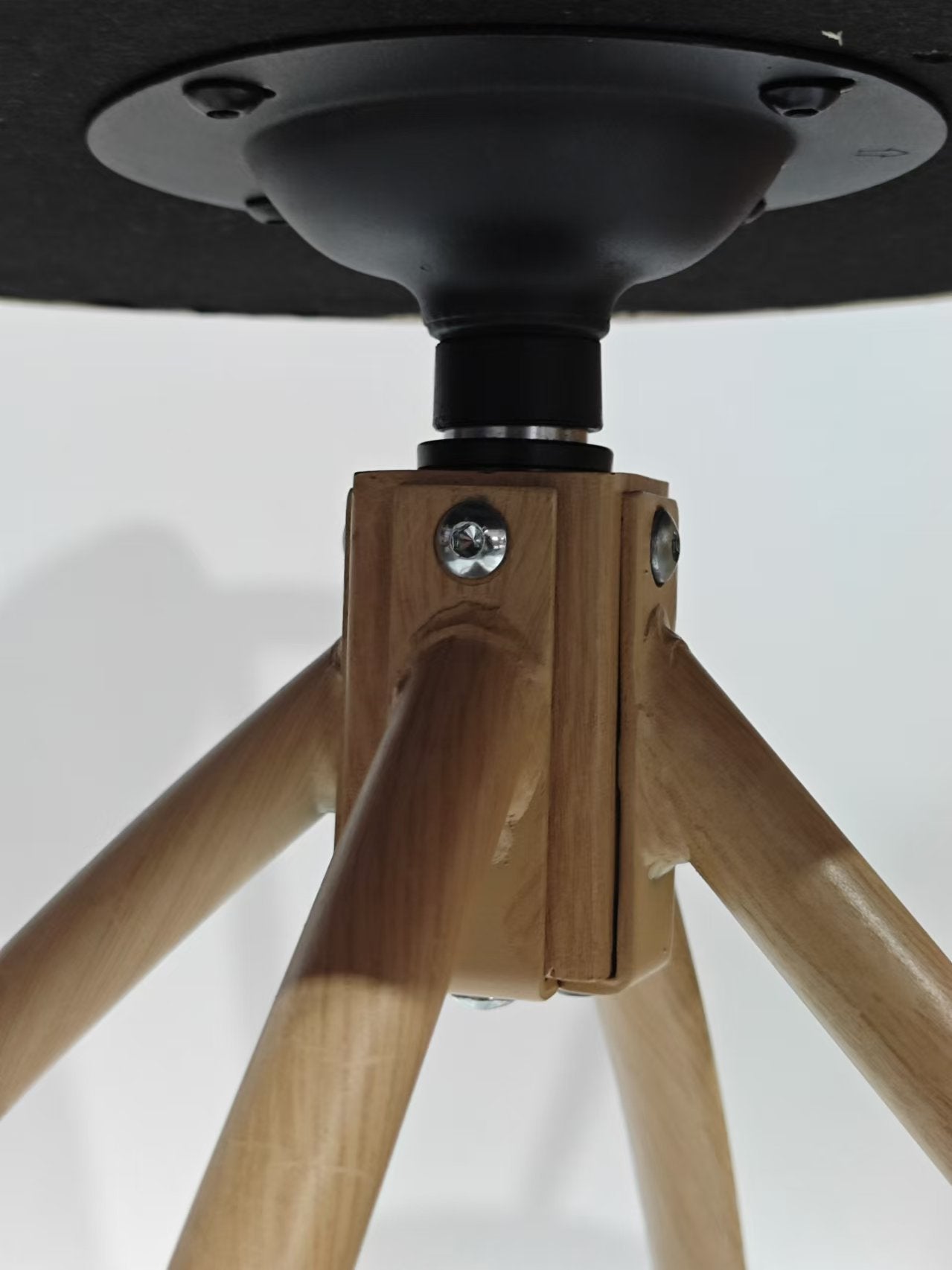 Wooden stool base with black metal accents and silver screws
