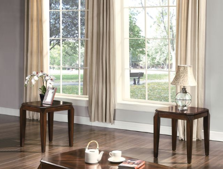 Dark wood end table with a framed picture and orchid
