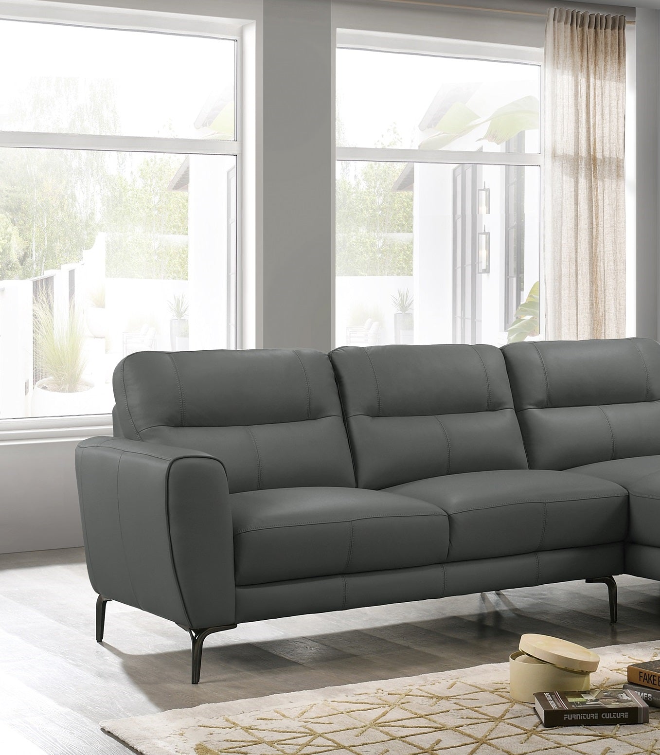 Contemporary charcoal grey leather sectional sofa with plush cushions and modern metal legs