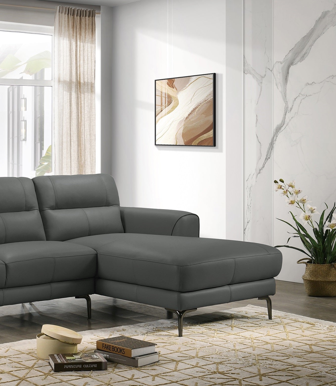 Dark gray leather sectional sofa with tufted back cushions and metal legs