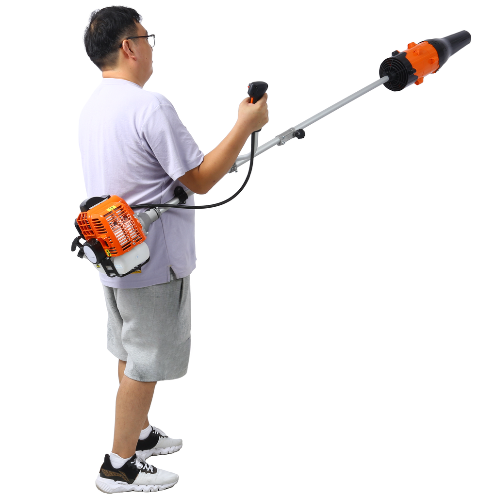 Man holding orange and black backpack leaf blower with long tube extension