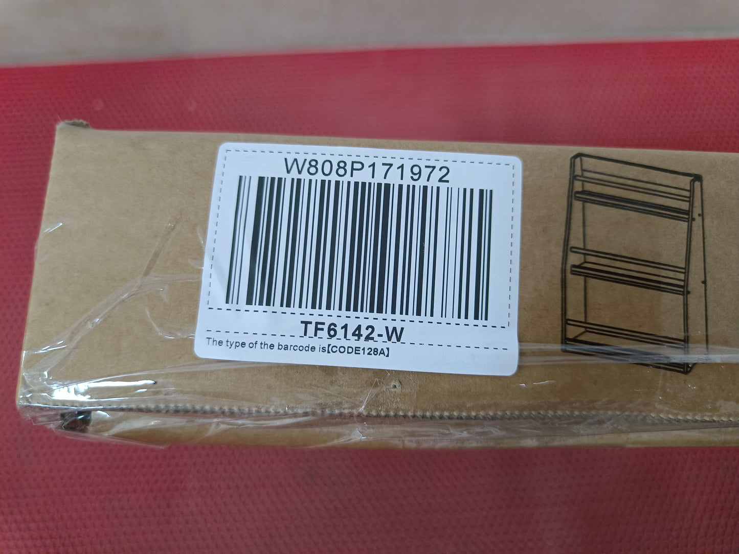 Cardboard box with a barcode sticker and line drawing of a shelf organizer