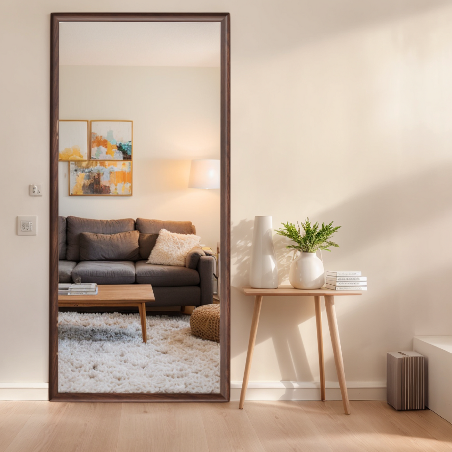 Tall floor mirror with a dark wood frame reflecting a modern living room interior