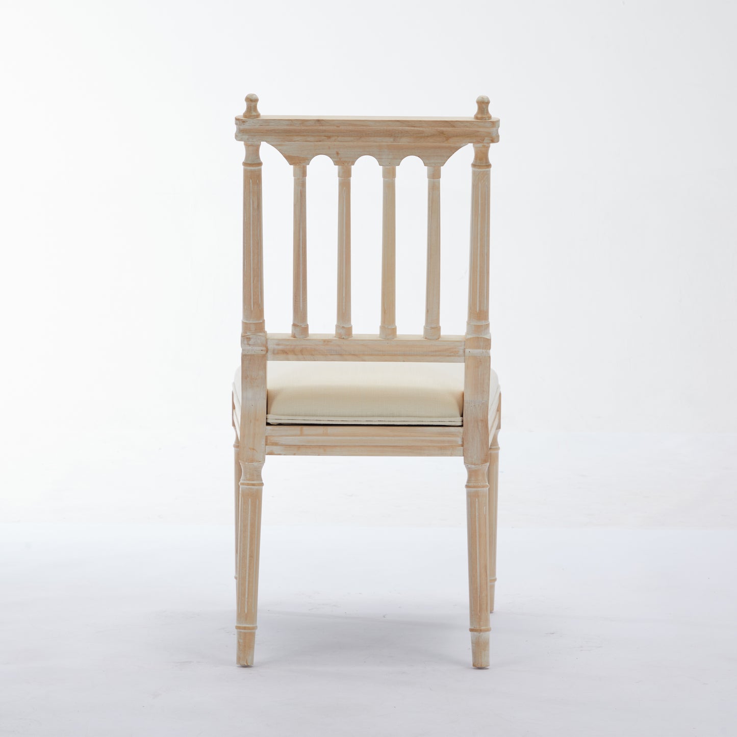 Distressed wood dining chair with a cane seat and decorative back splats perfect for a farmhouse aesthetic