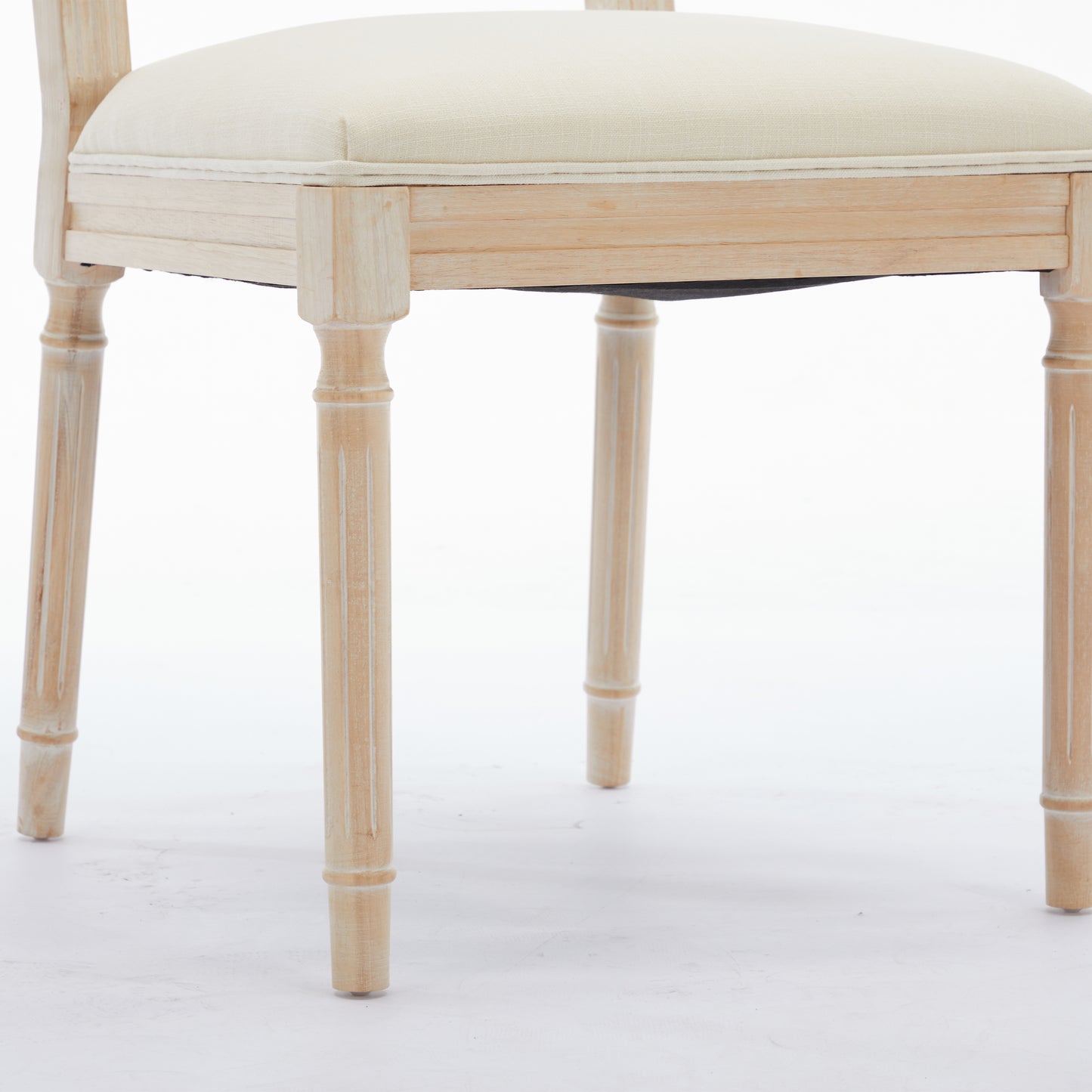 Light wood dining chair with upholstered cream seat and fluted legs