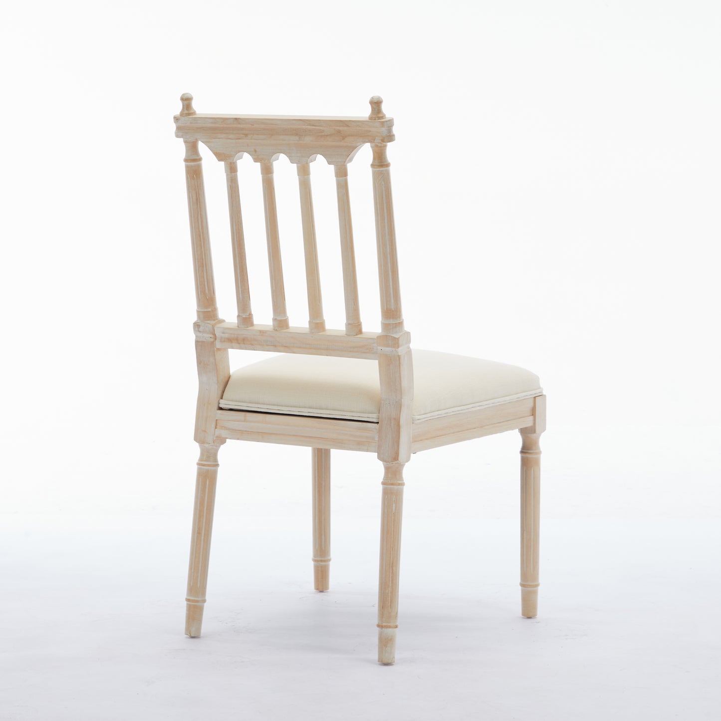 Light wood dining chair with a cream upholstered seat and spindle back