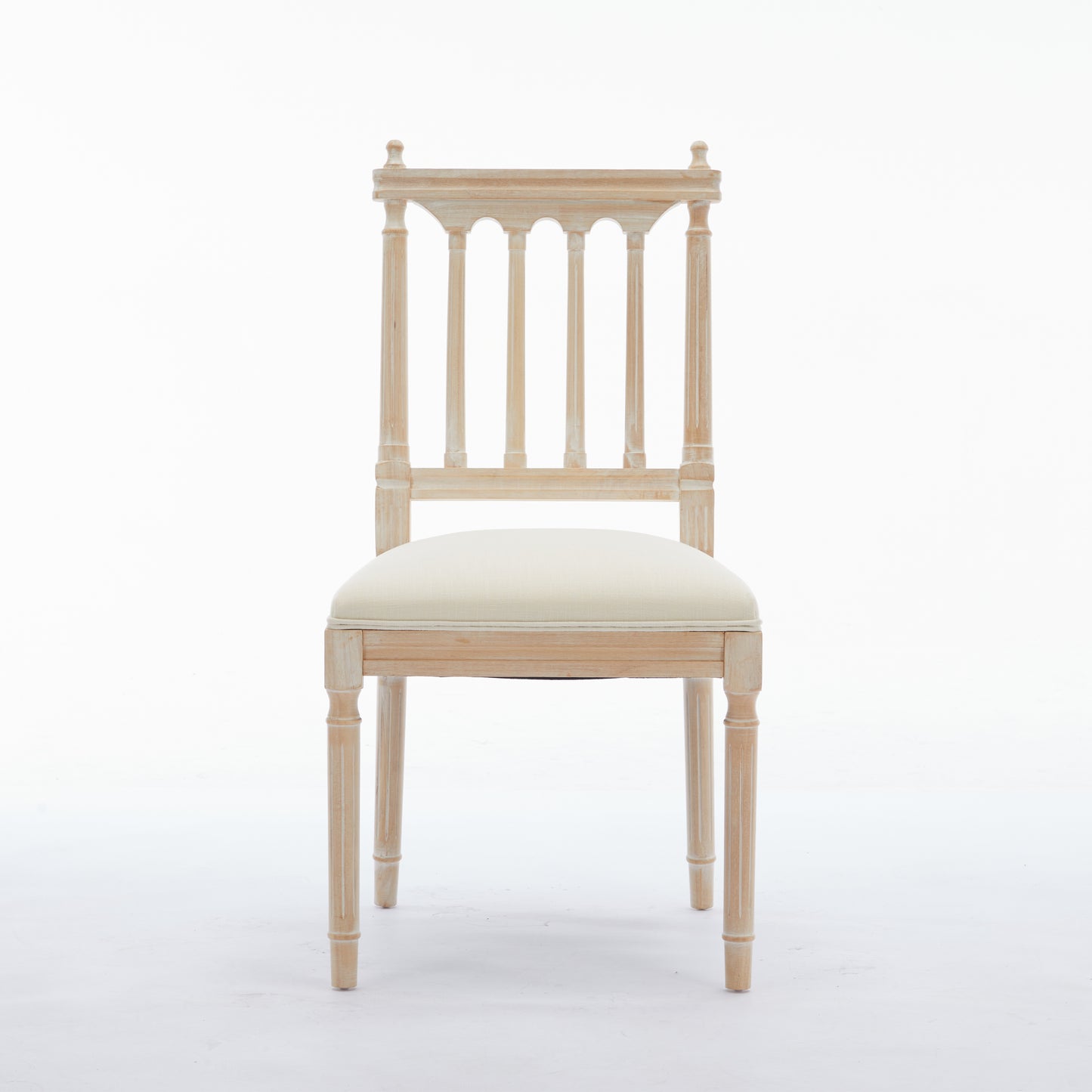 Light wood dining chair with white upholstered seat and spindle back