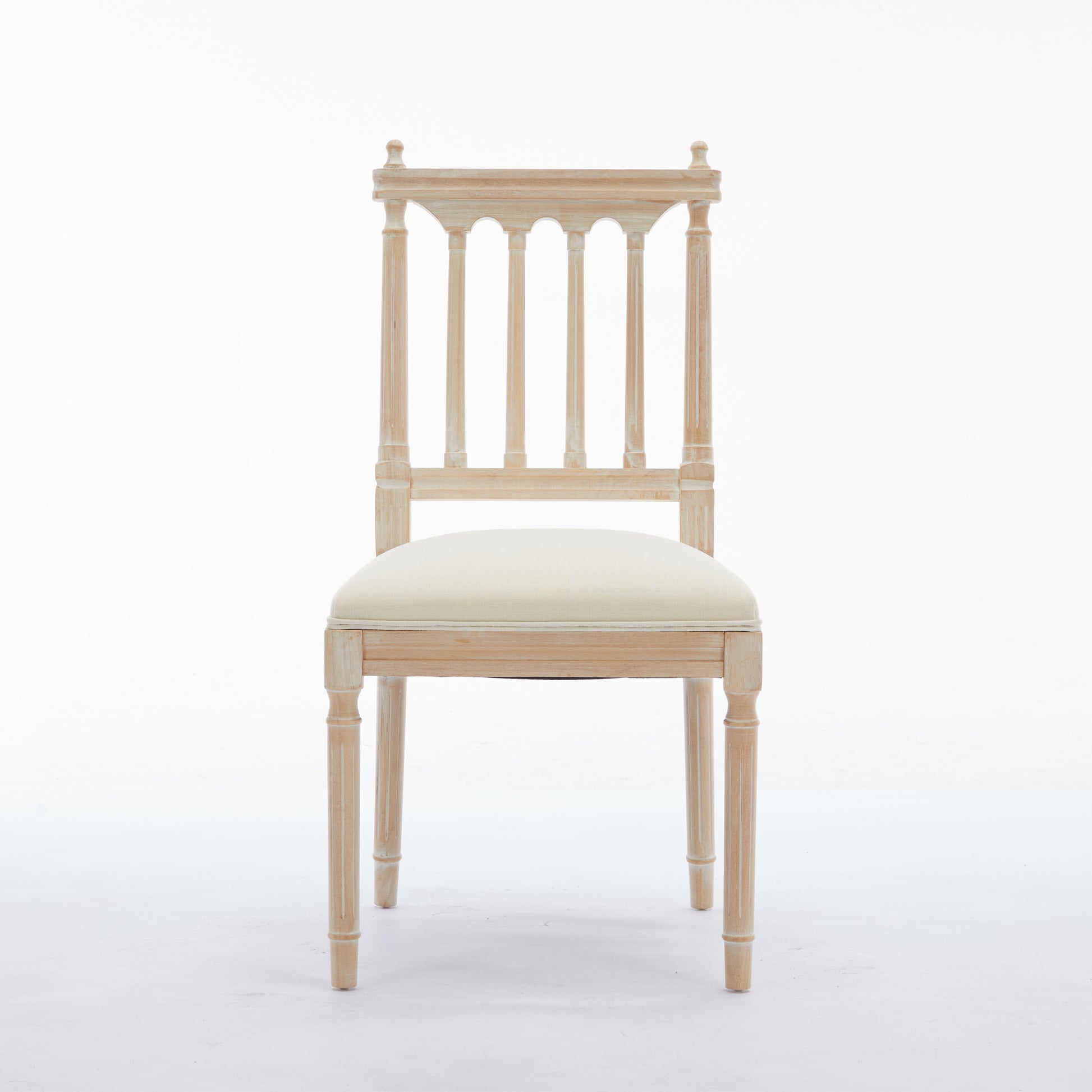 Light wood dining chair with white upholstered seat and spindle back