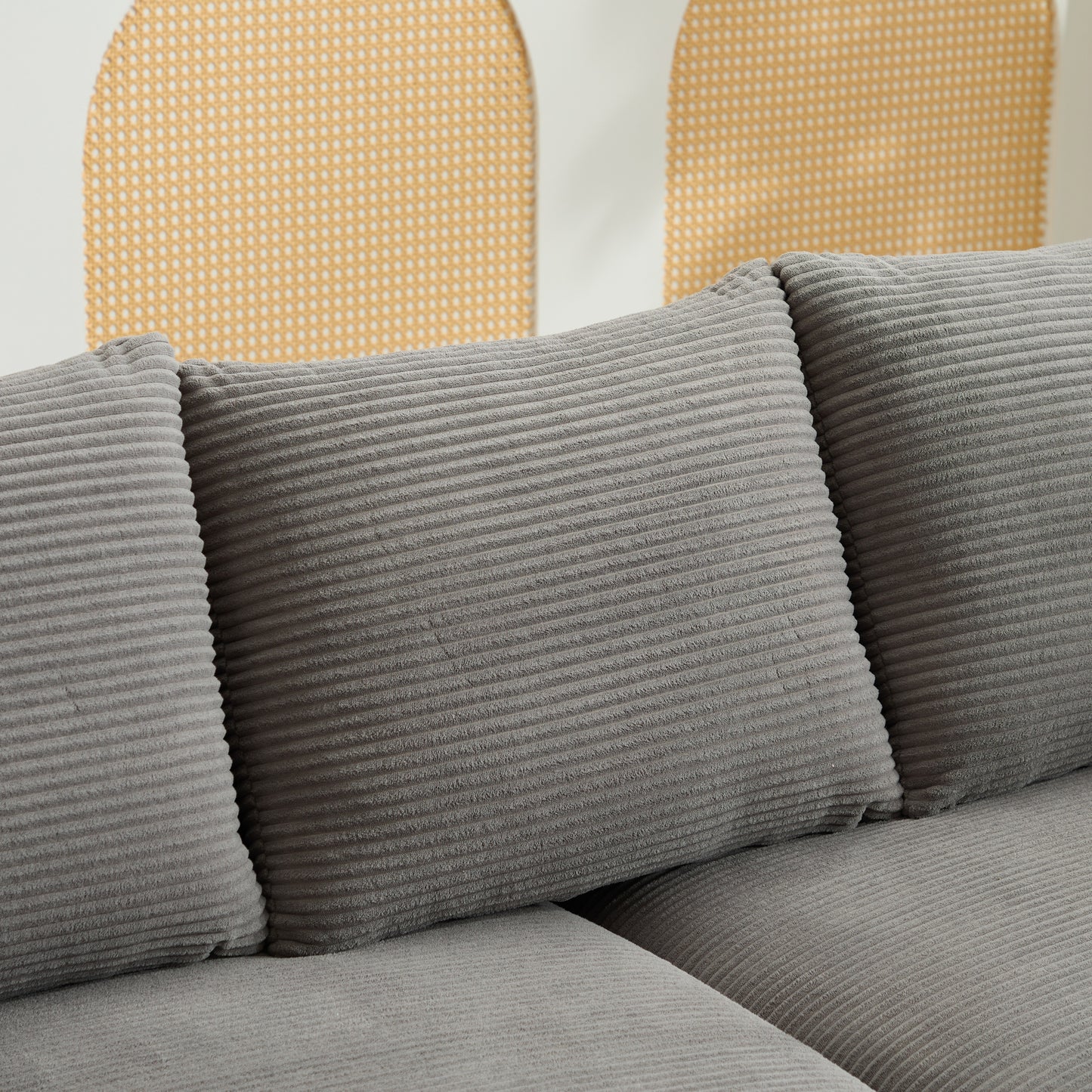 Close up of plush gray corduroy sofa cushions with a textured ribbed design for comfort