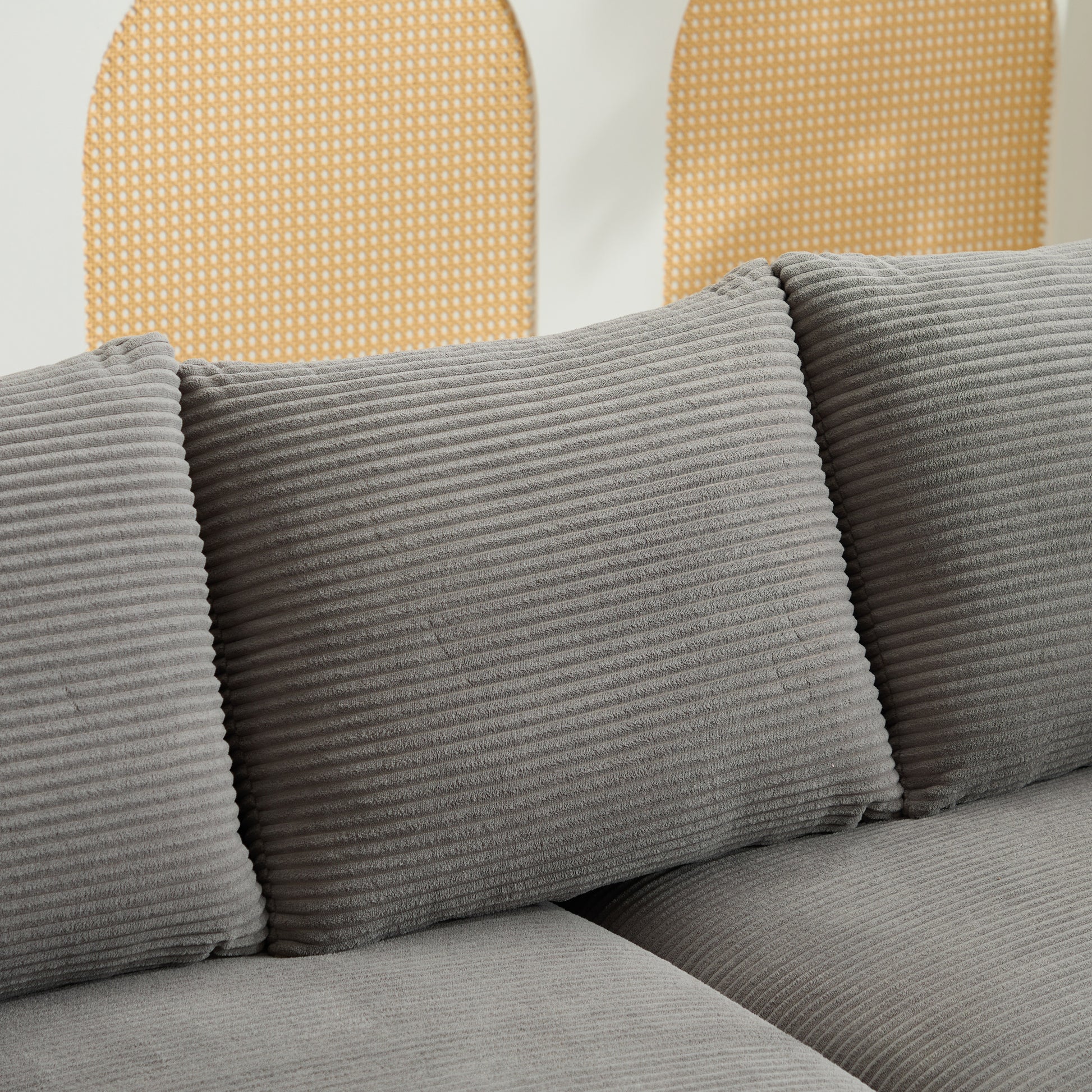 Close up of plush gray corduroy sofa cushions with a textured ribbed design for comfort