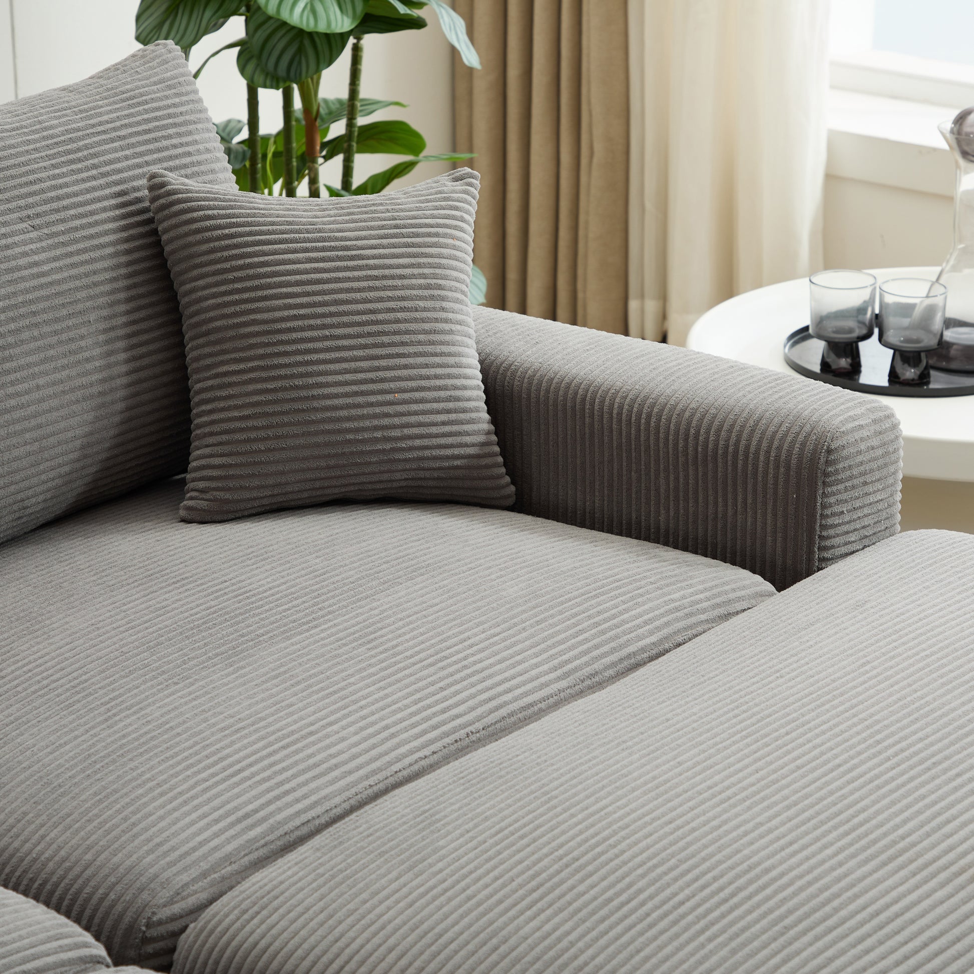 Closeup of a grey corduroy sofa cushion with textured stripes
