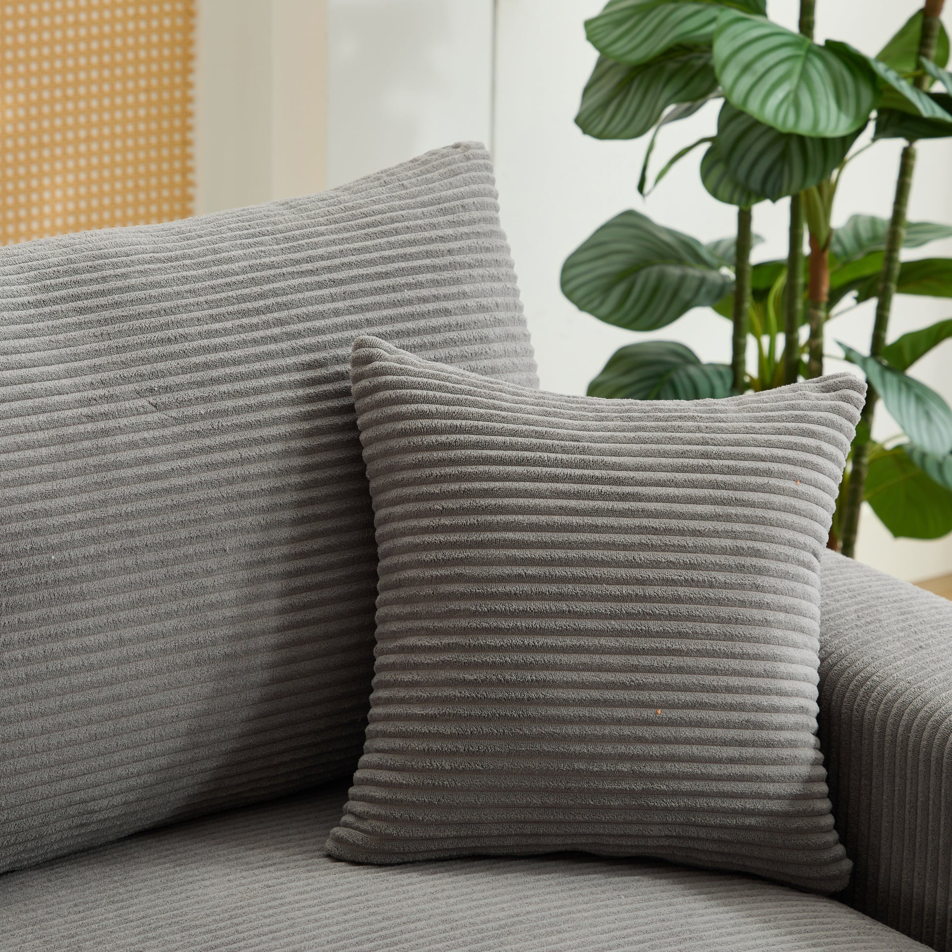 Gray corduroy throw pillow with textured ribbing for a cozy accent