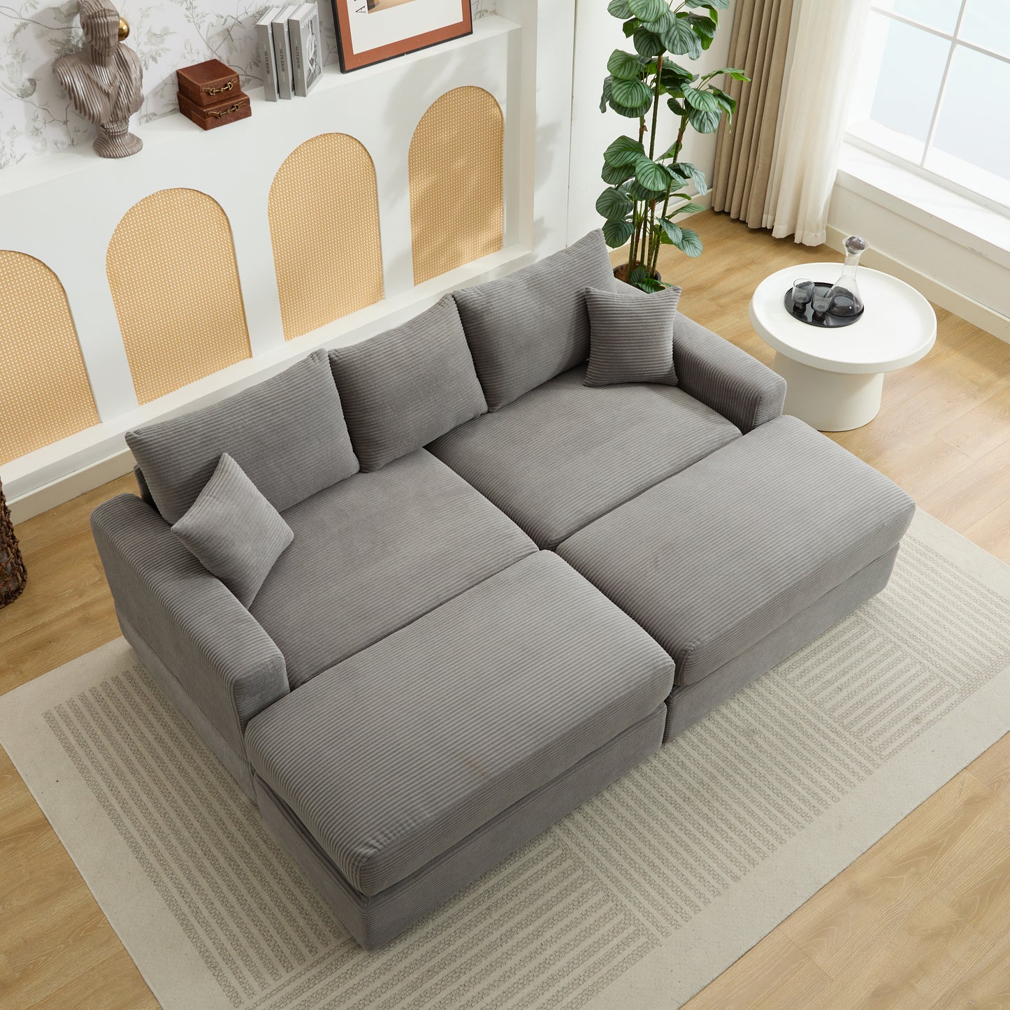 Gray corduroy sectional sofa with plush cushions and an ottoman Perfect for modern living rooms