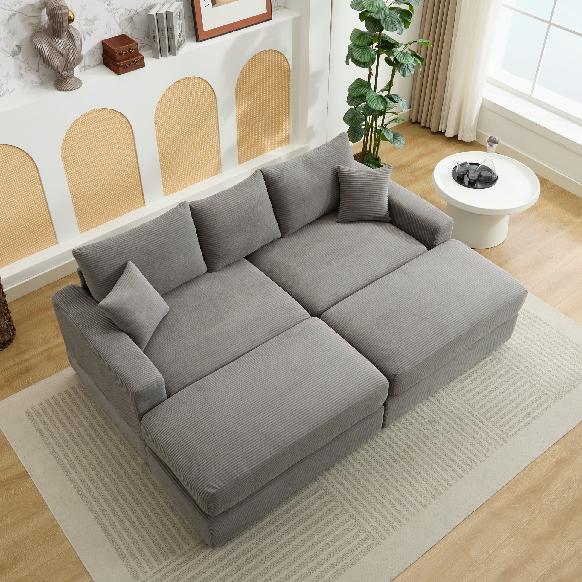 Gray corduroy sectional sofa with plush cushions and an ottoman Perfect for modern living rooms