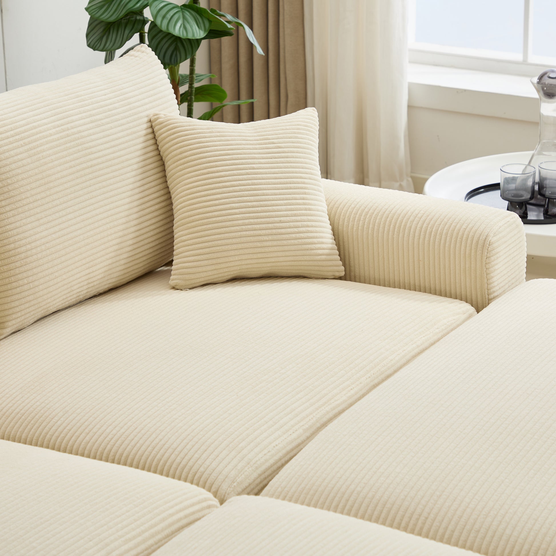 Cream corduroy couch with plush cushions and textured fabric detail